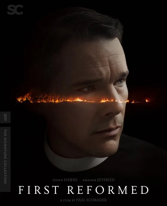 A promotional poster for the movie 'First Reformed' featuring Ethan Hawke with a landscape of fire and smoke running across his face.
