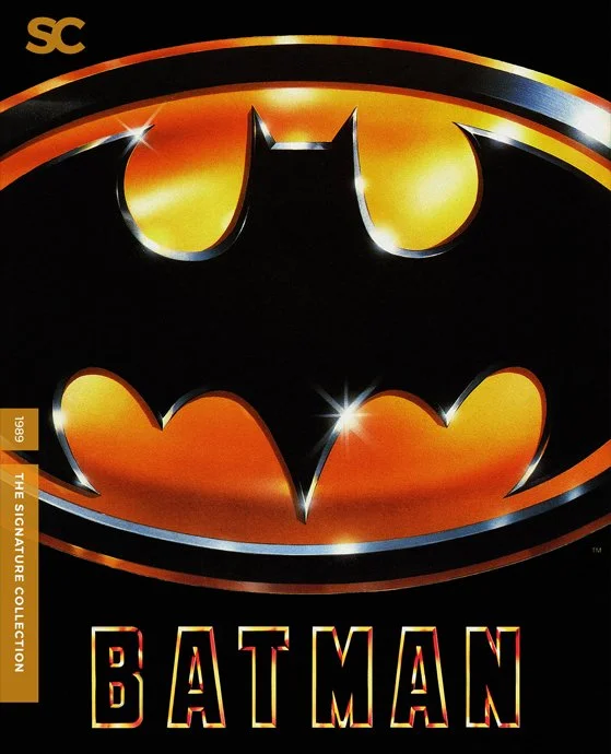 Batman logo with orange and yellow glow, and the text 'BATMAN' below it.