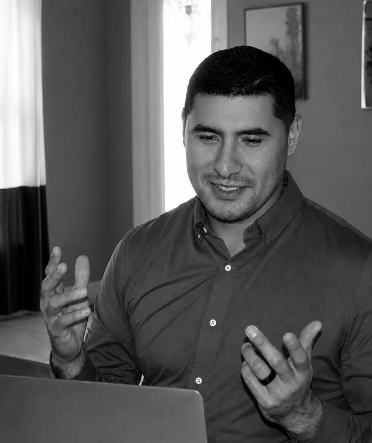 Tony Lopez listening and gesturing during a secure online therapy session.