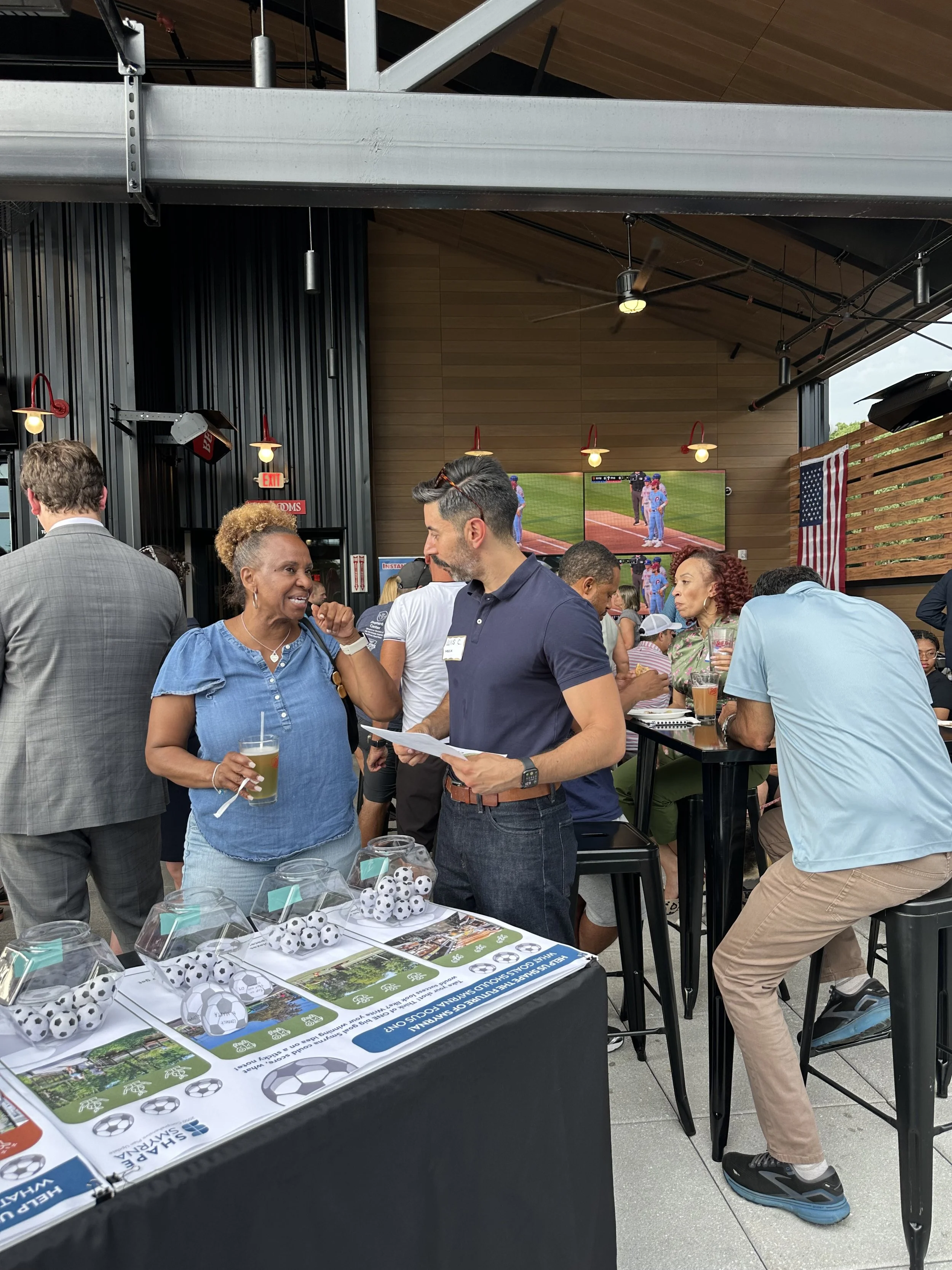 Planner discussing the future of Smyrna with participants at an activity booth