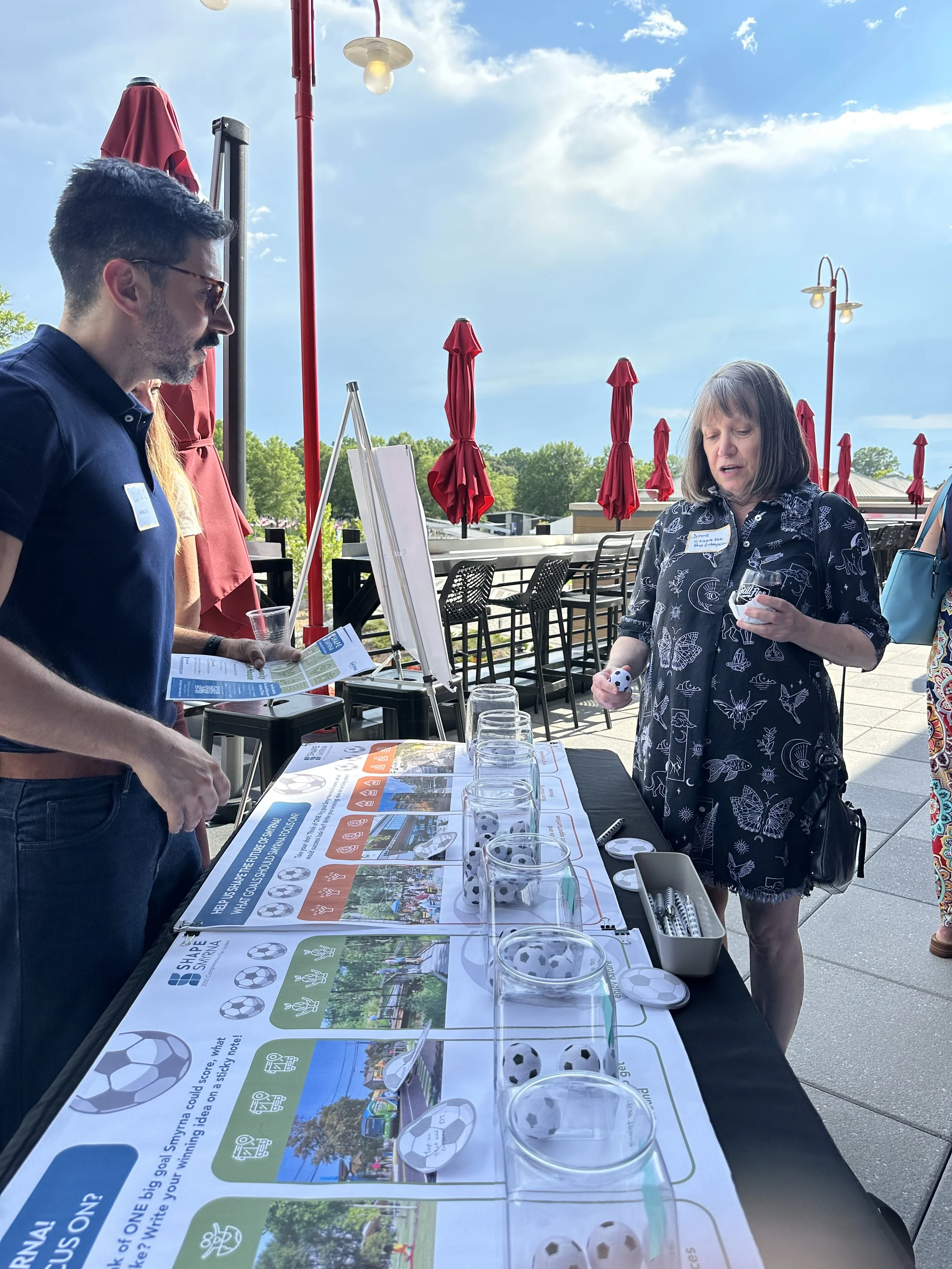 Planner discussing the future of Smyrna with a participant at an activity booth