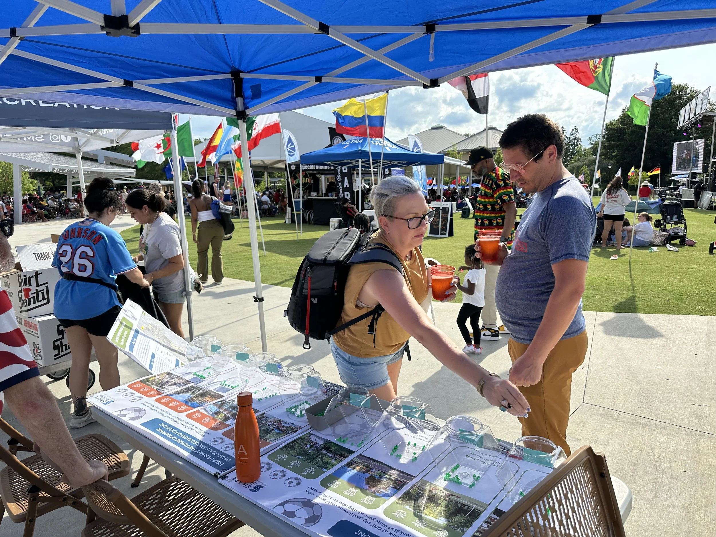 Two participants are giving their feedback at the Juneteenth activity booth