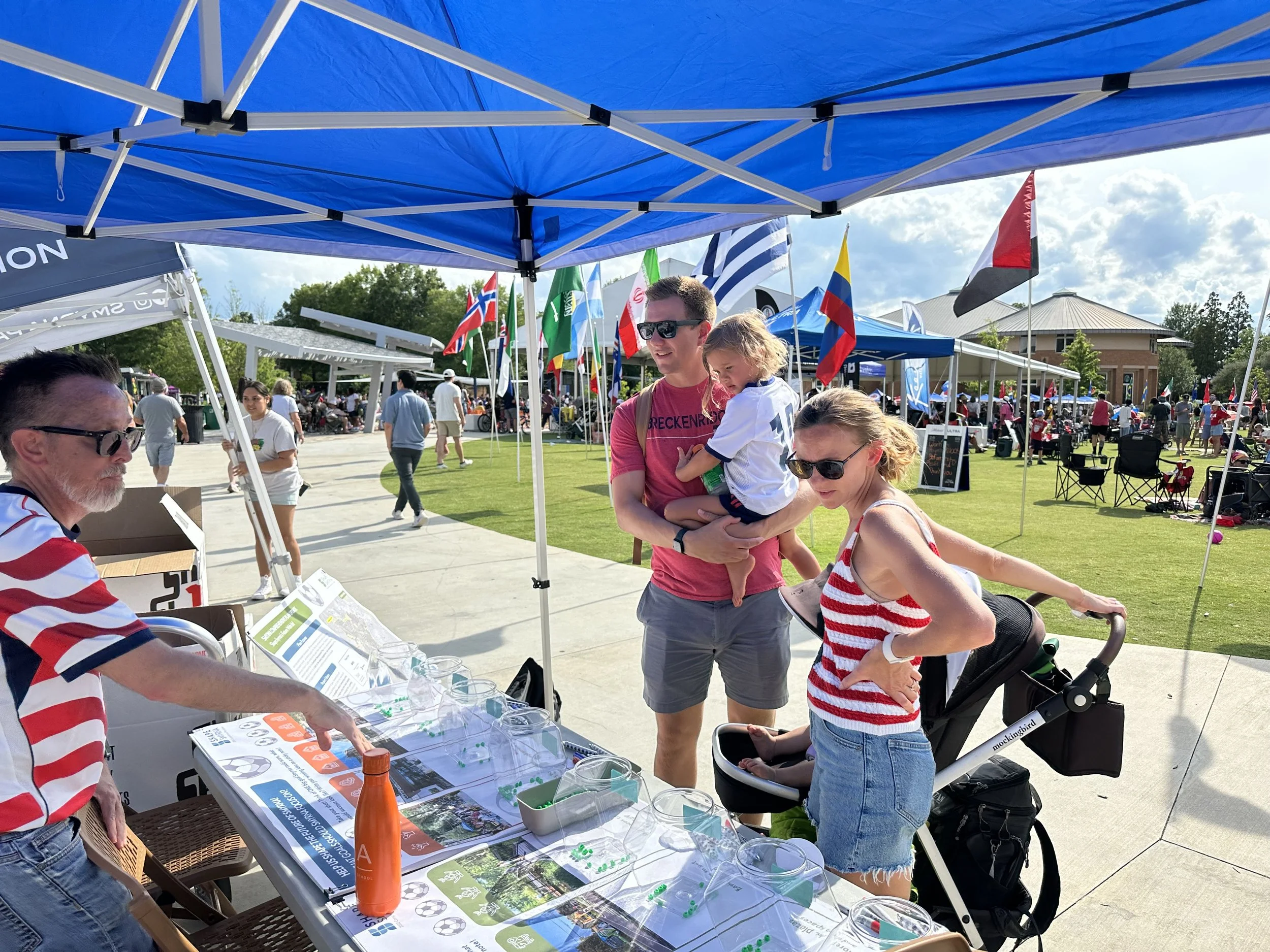 A family discussing the future of Smyrna with City staff at a festival booth
