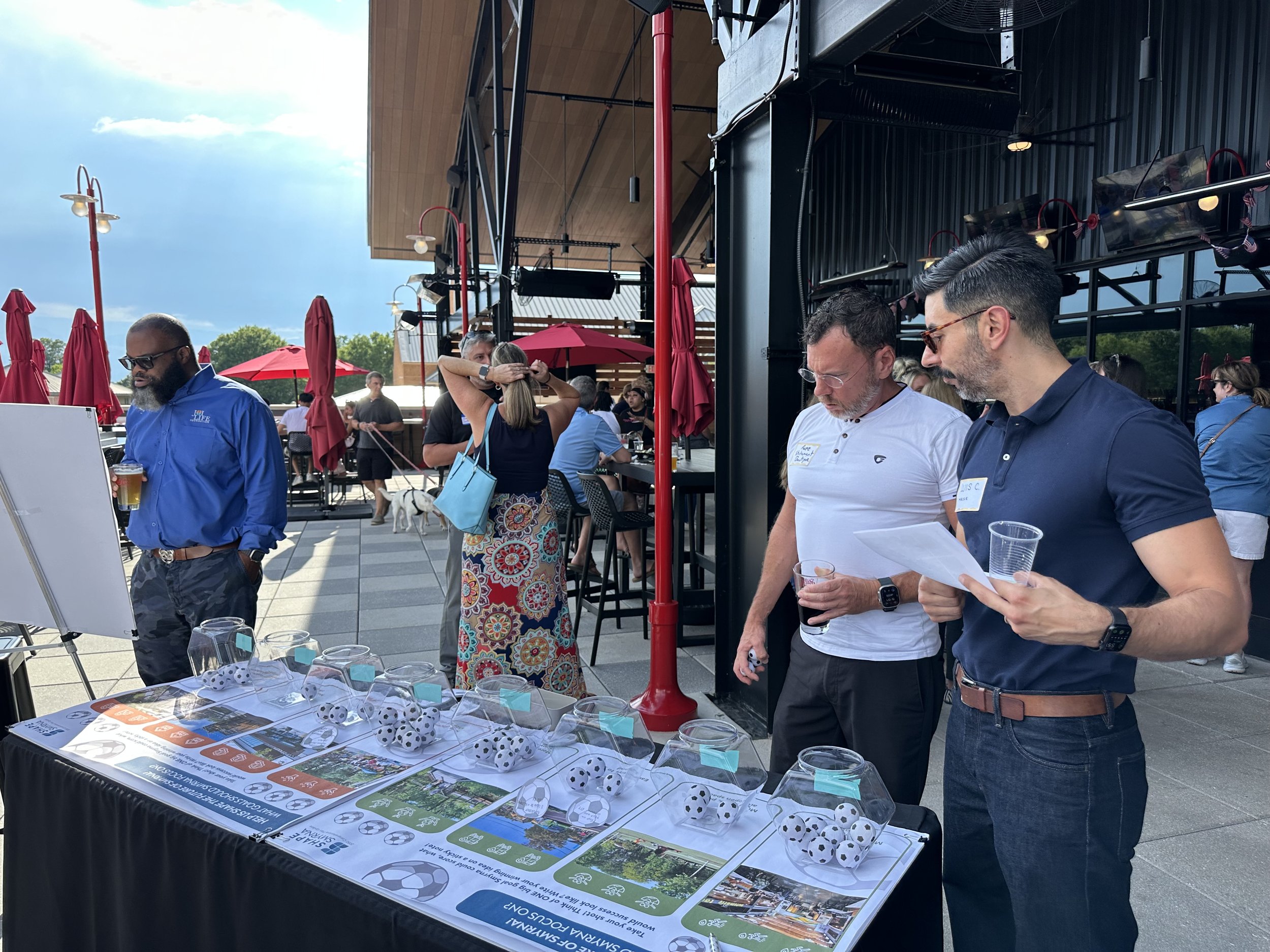 Planner discussing the future of Smyrna with a gentleman at an activity booth