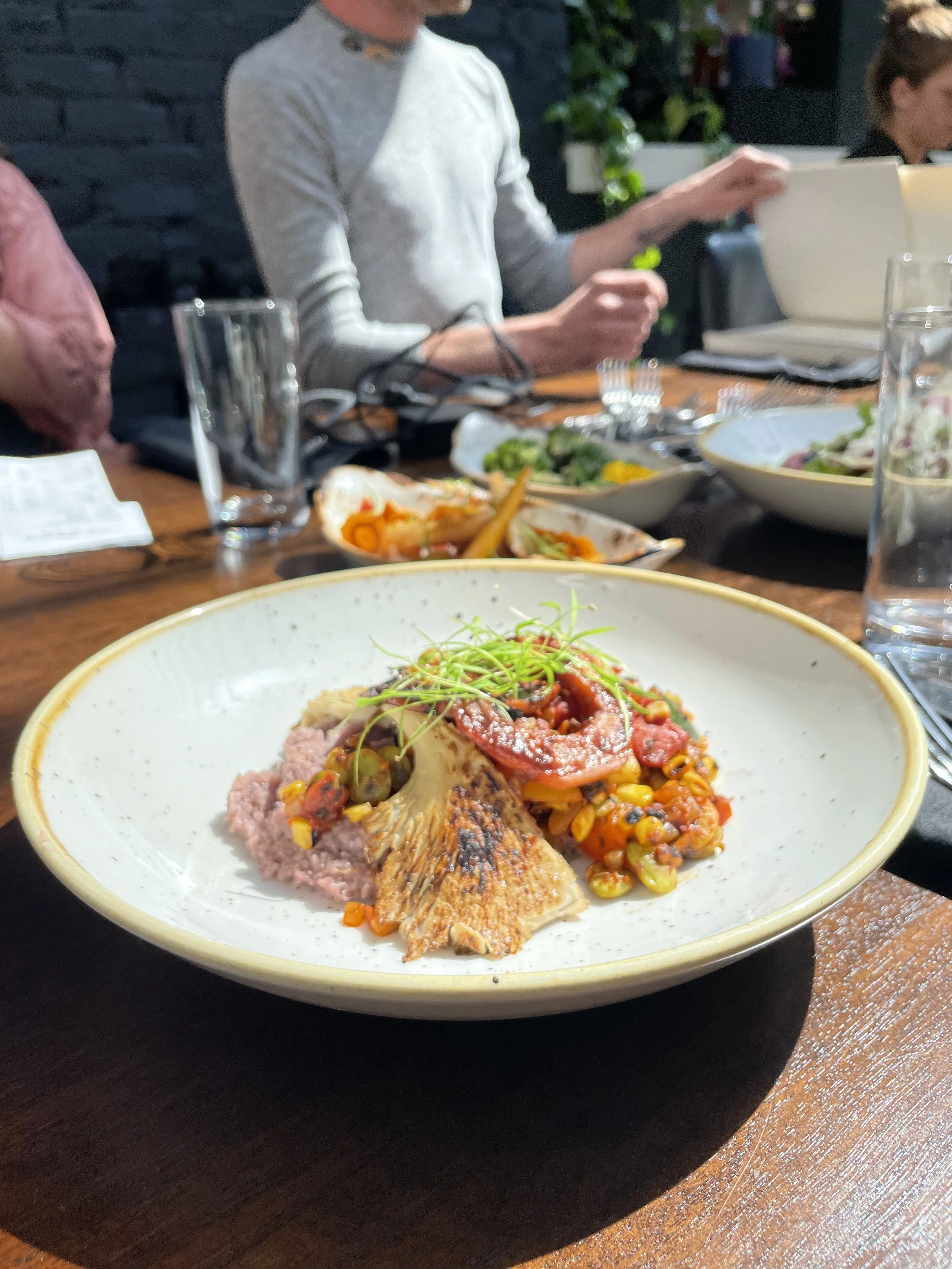 Plated meal at a table after a group cooking class