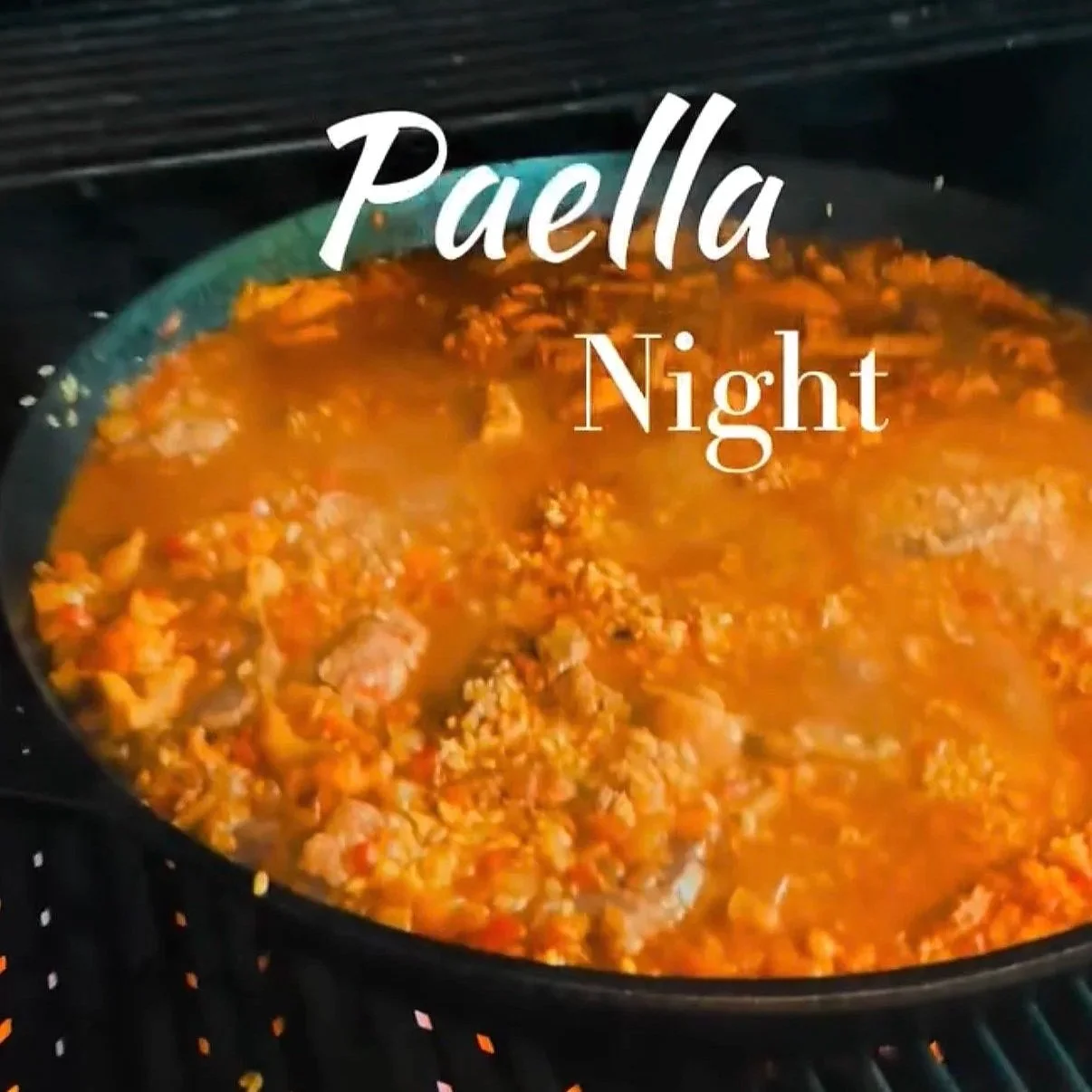 Pan of cooking Paella with the words Paella Night on photo