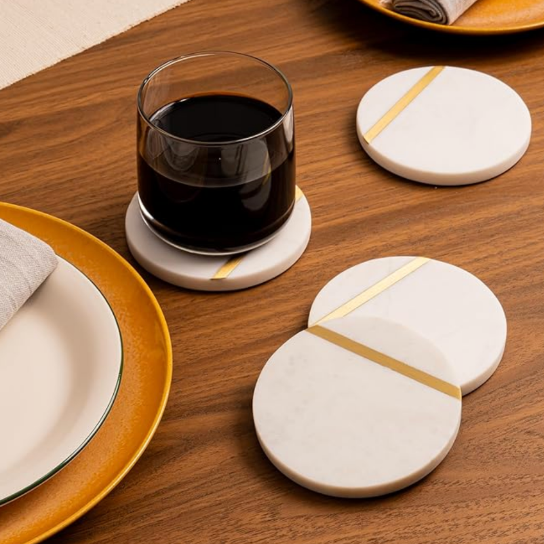 Red wine and white dinnerware styled on a wood table for curated dining and entertaining.