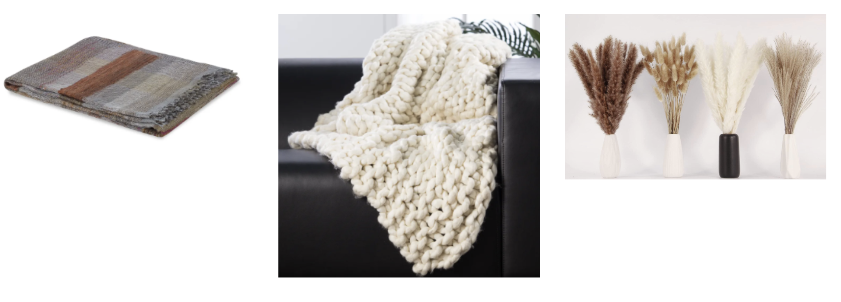 A folded plaid blanket, a chunky knit cream throw on a black chair, and four vases filled with dried grasses.