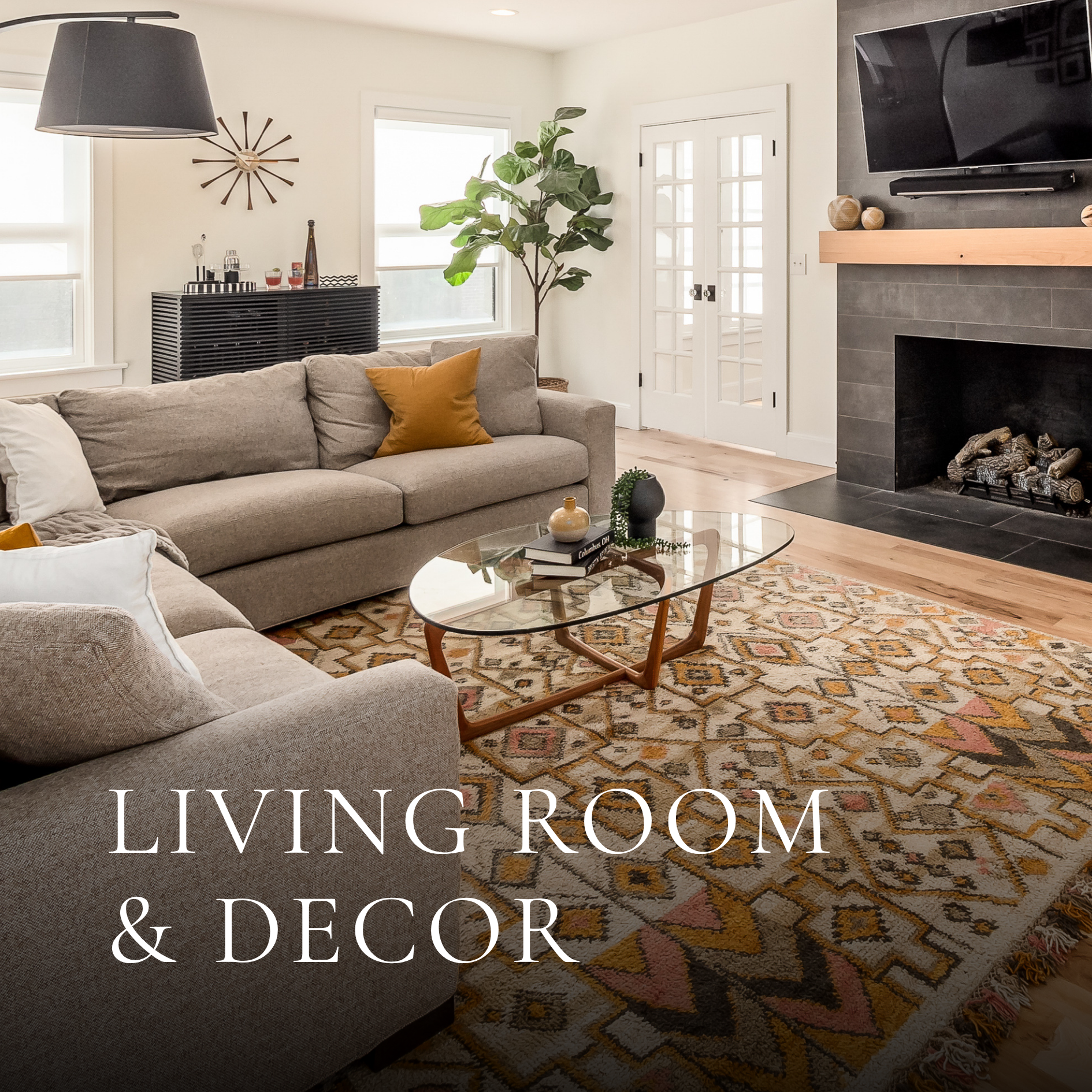 Residential living room design featuring neutral sofas, patterned rug, fireplace, glass coffee table and indoor greenery.