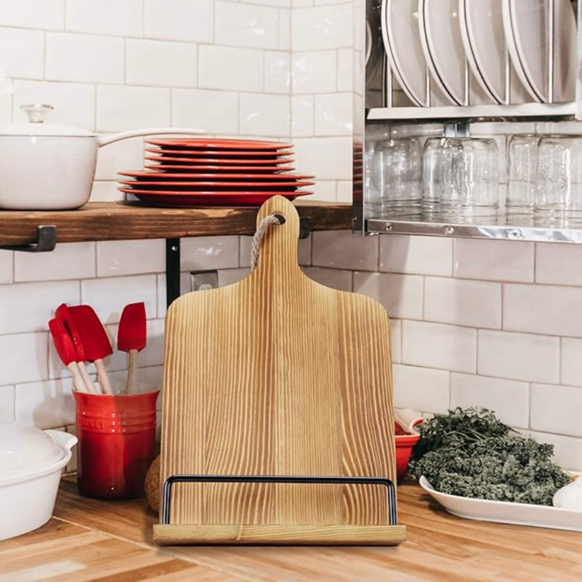 Styled kitchen storage featuring red and white dinnerware, utensils, open shelving and decorative accents.