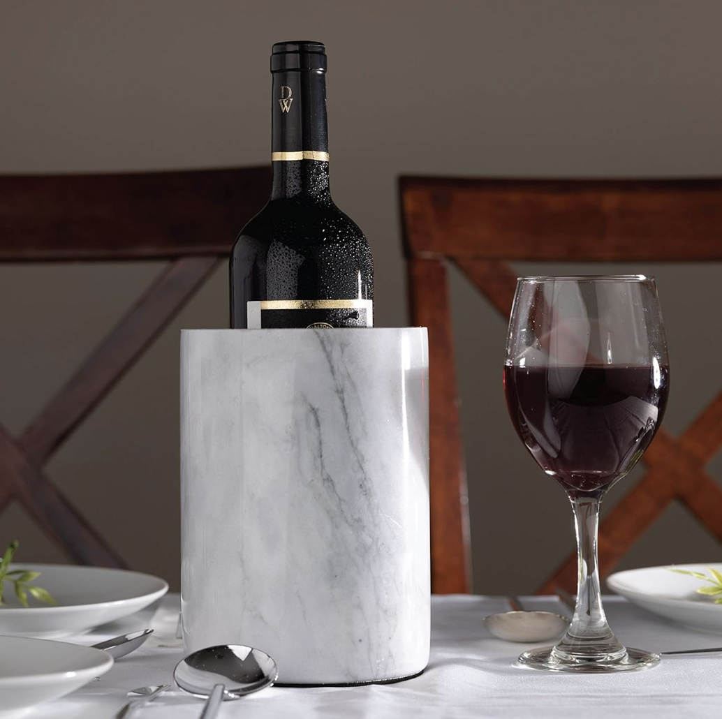 Red wine, marble wine holder and dinnerware styled for an elegant dining and entertaining space.