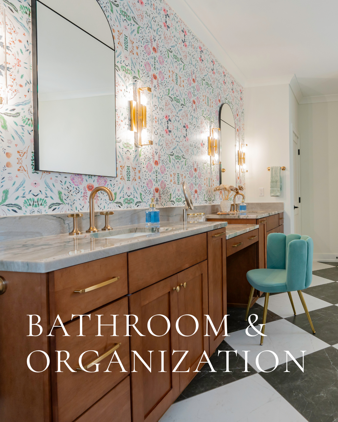 Eclectic bathroom interior featuring floral wallpaper, wood vanity, marble countertops and black-and-white checkered flooring.