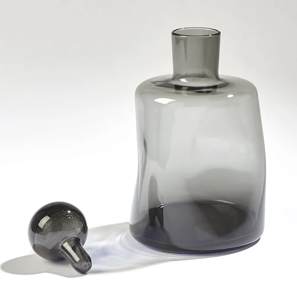 Gray and black decorative glass accessories styled as modern home decor.