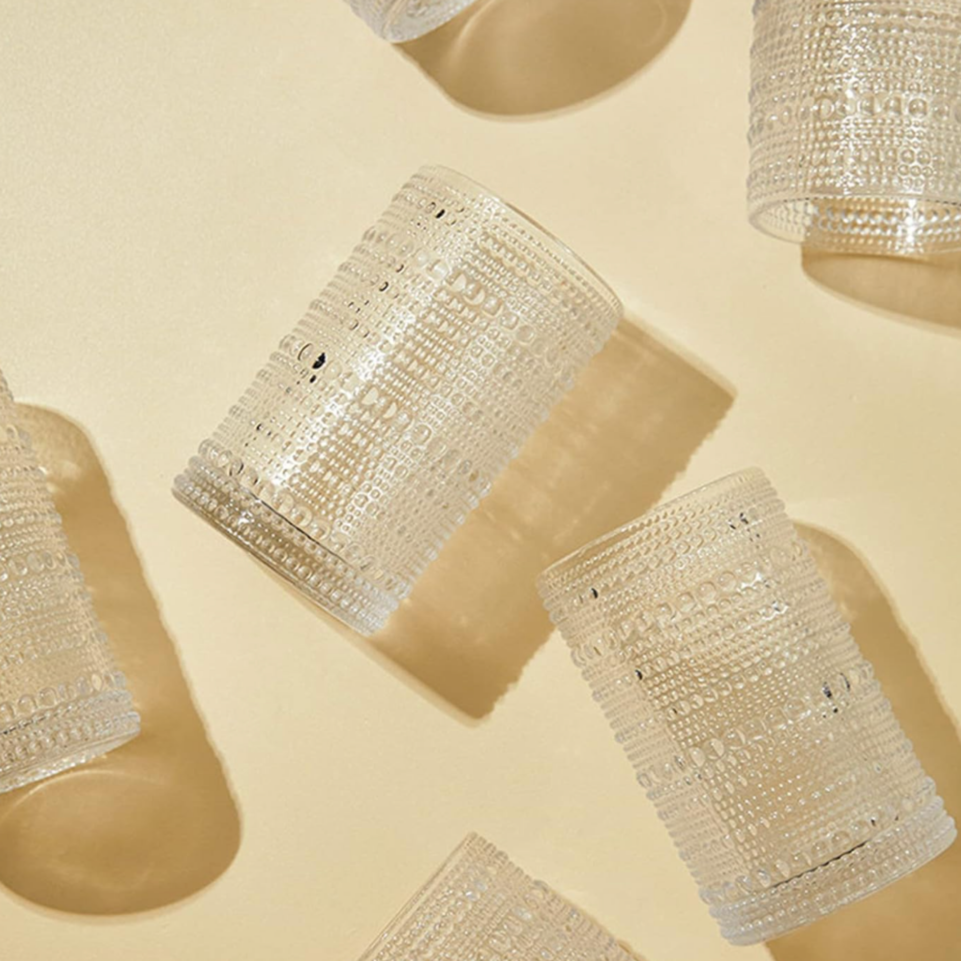 Textured decorative glass objects with intricate beaded detailing for curated home decor.
