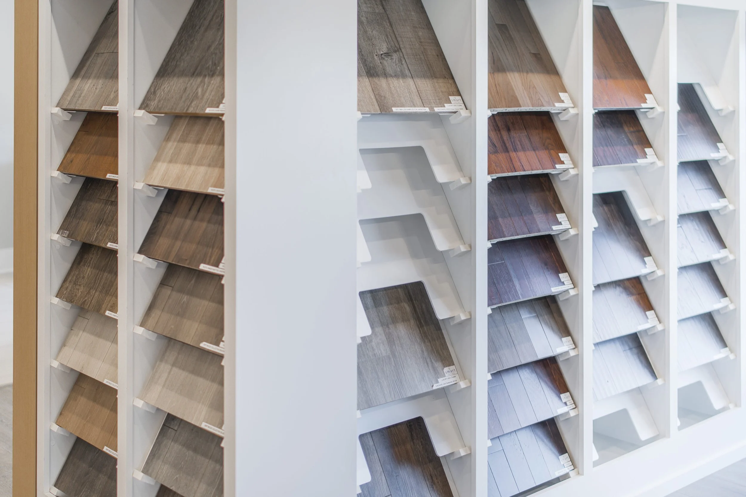 Display racks containing various wood and laminate flooring samples.