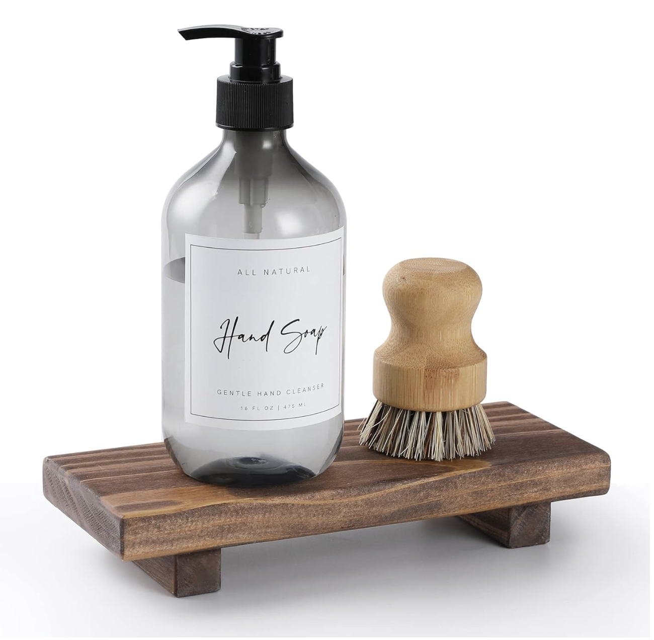 Natural hand soap and wood scrub brush styled on a wooden soap dish for bathroom decor.