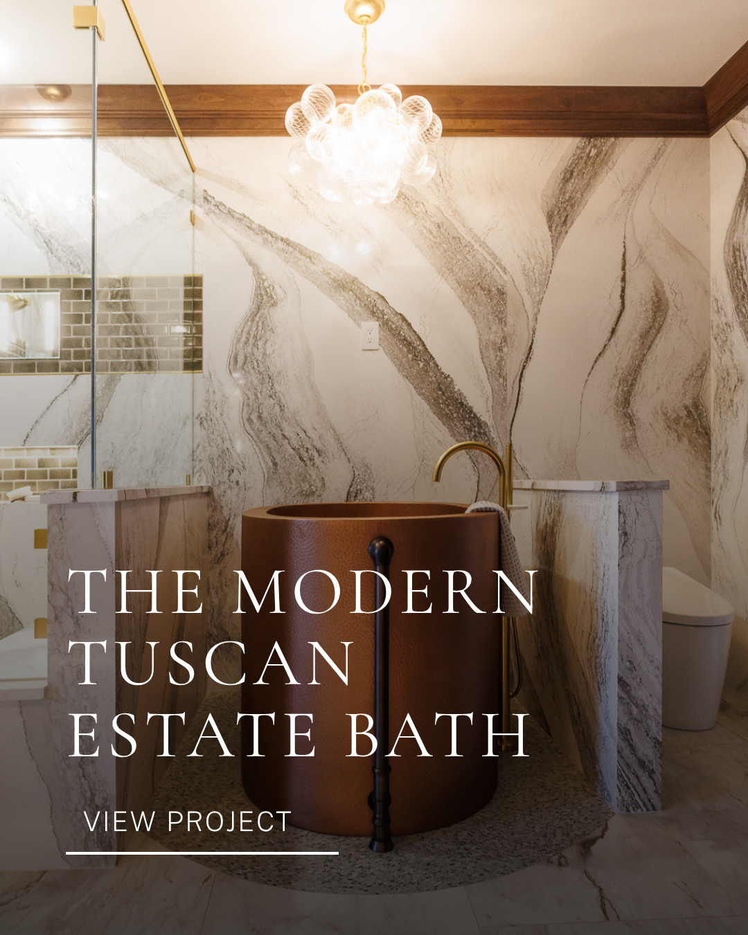 Residential bathroom interior design featuring a freestanding tub, marble walls, gold fixtures and statement lighting.
