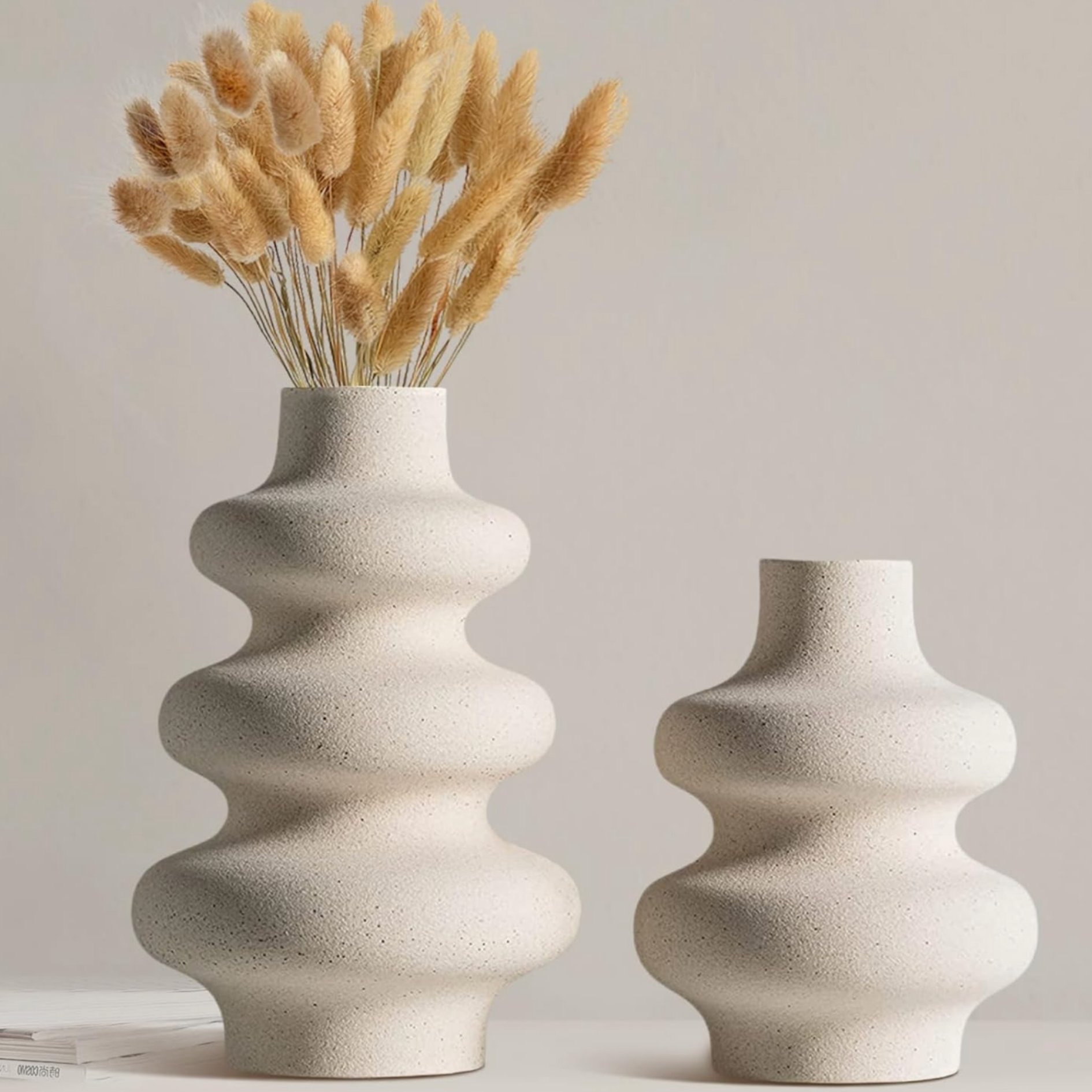 Neutral decorative vases styled with dried pampas grass for modern home decor.