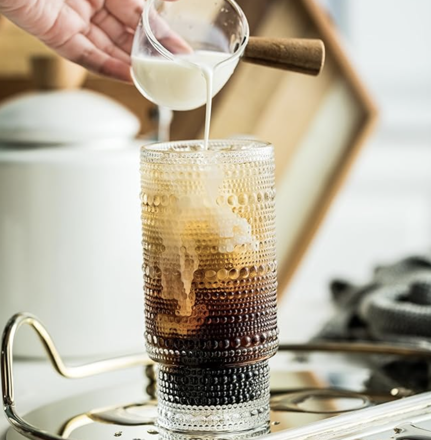 Textured glass tumbler with iced coffee and milk for stylish kitchen and entertaining essentials.