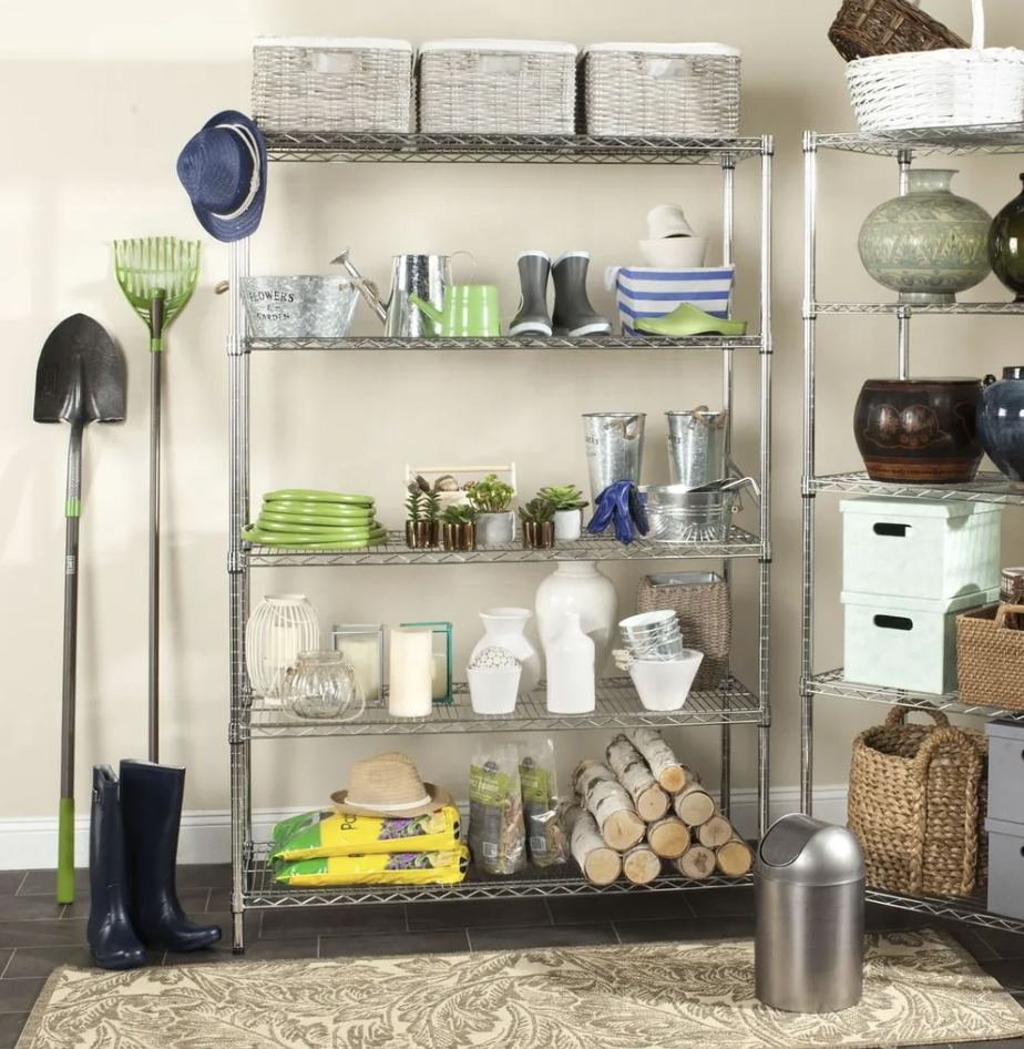 Organized metal shelving with gardening tools, storage boxes and decorative home accessories.
