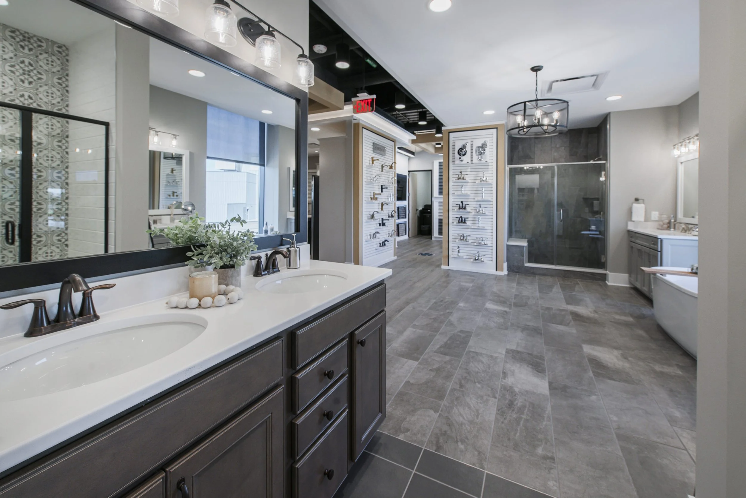 A showroom displaying bathroom vanities, faucets, and shower enclosures.