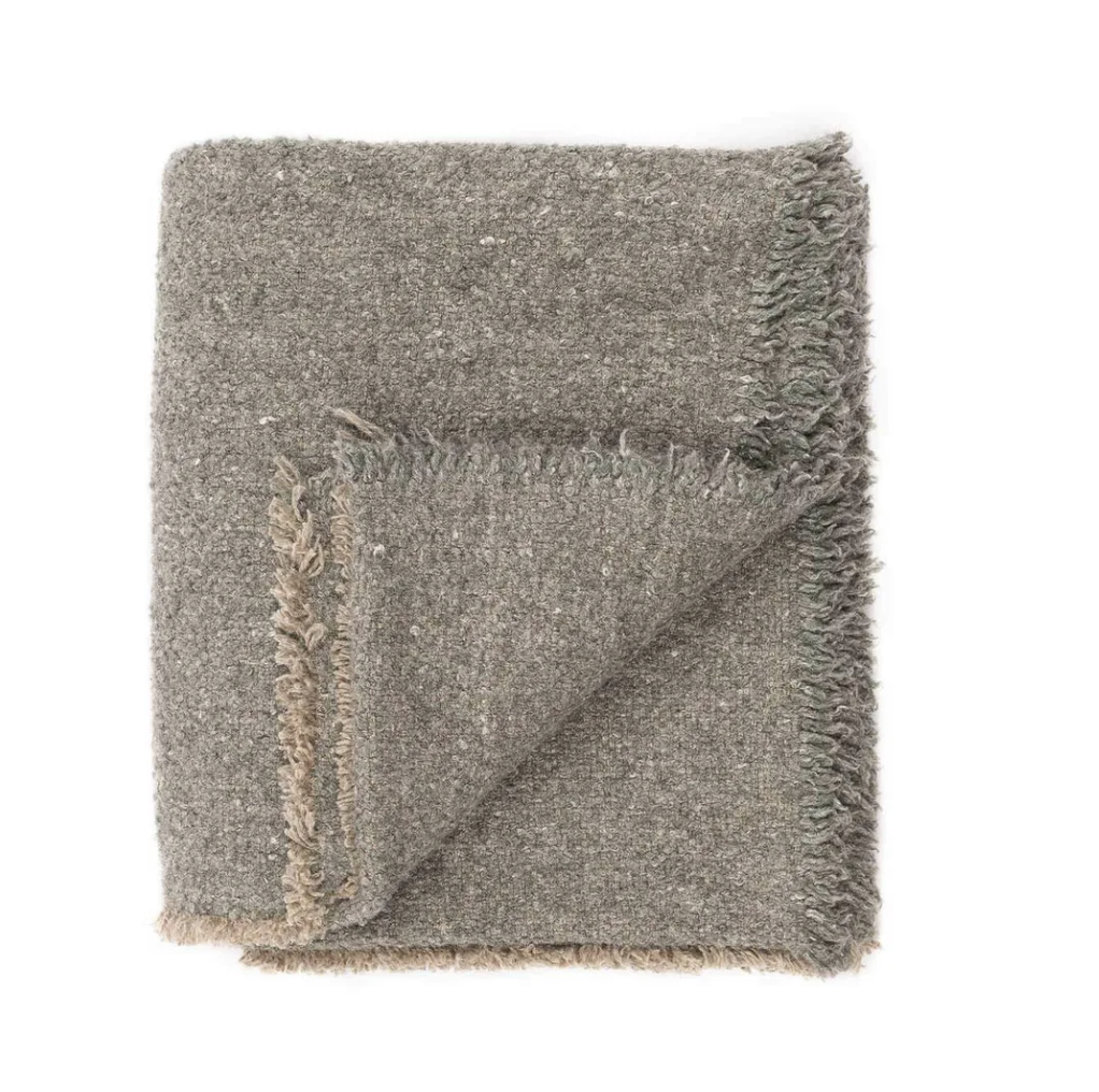 Gray textured towel with fringed edges for bathroom styling and curated home essentials.