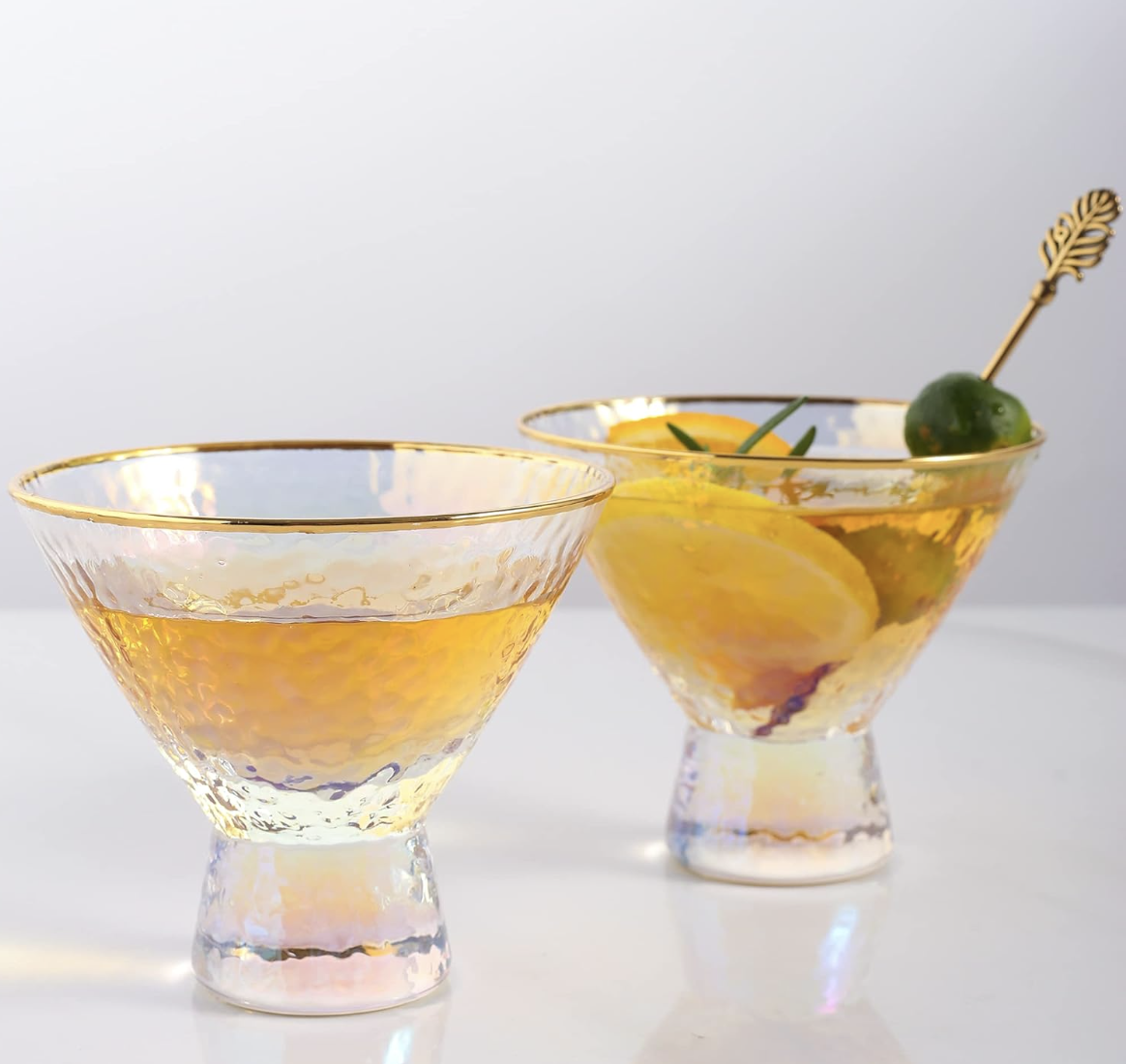 Yellow cocktails with lemon and olive garnish in modern glassware for home entertaining.