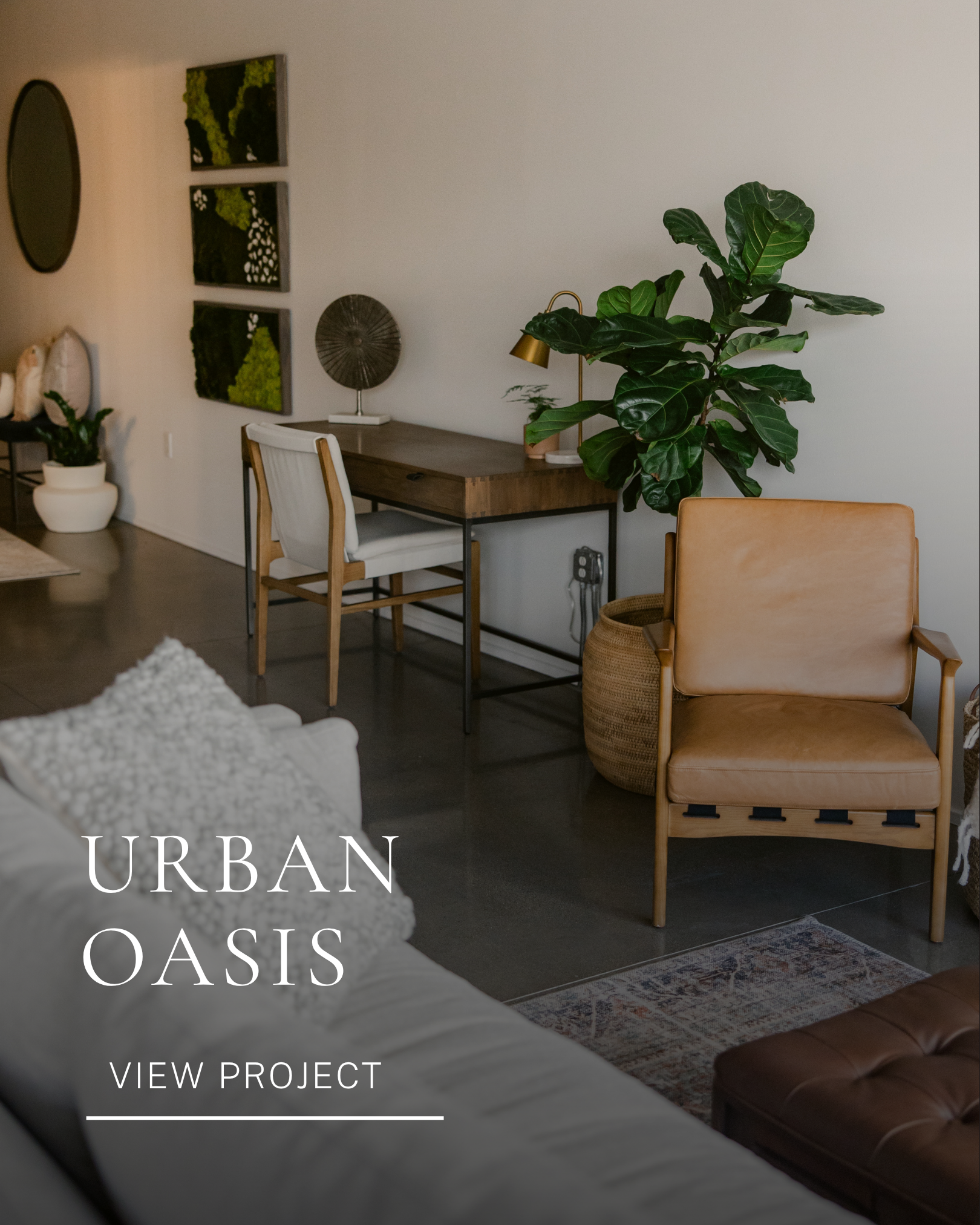 Modern residential living room and home office with neutral furnishings, leather seating and natural greenery.