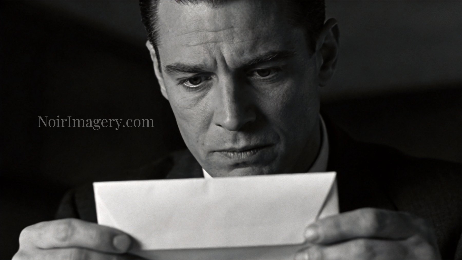 Close-up black-and-white portrait of a worried man reading a letter under dramatic noir lighting.