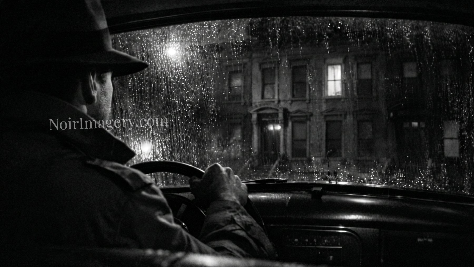 Detective watching a city building from inside a parked car during a rainy nighttime surveillance investigation.