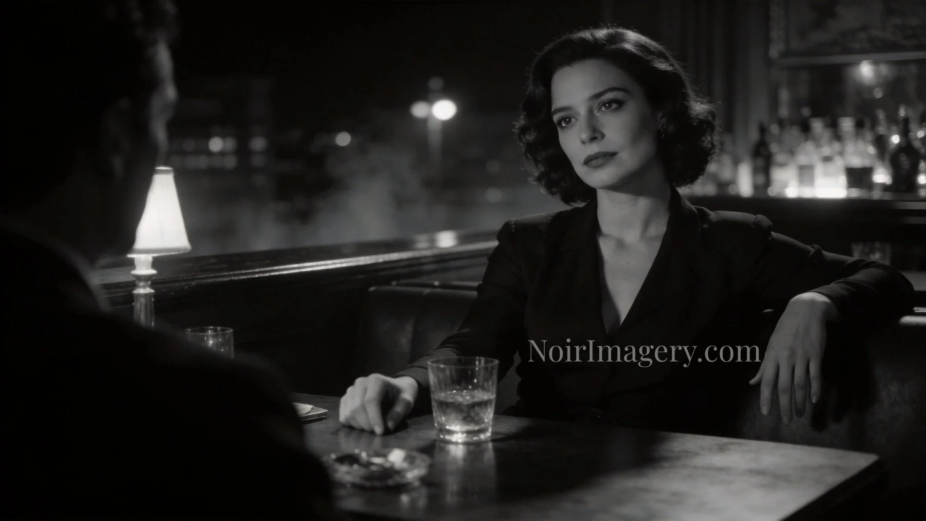 Confident noir woman seated across from an unseen man in a dim lounge, calmly controlling the conversation.