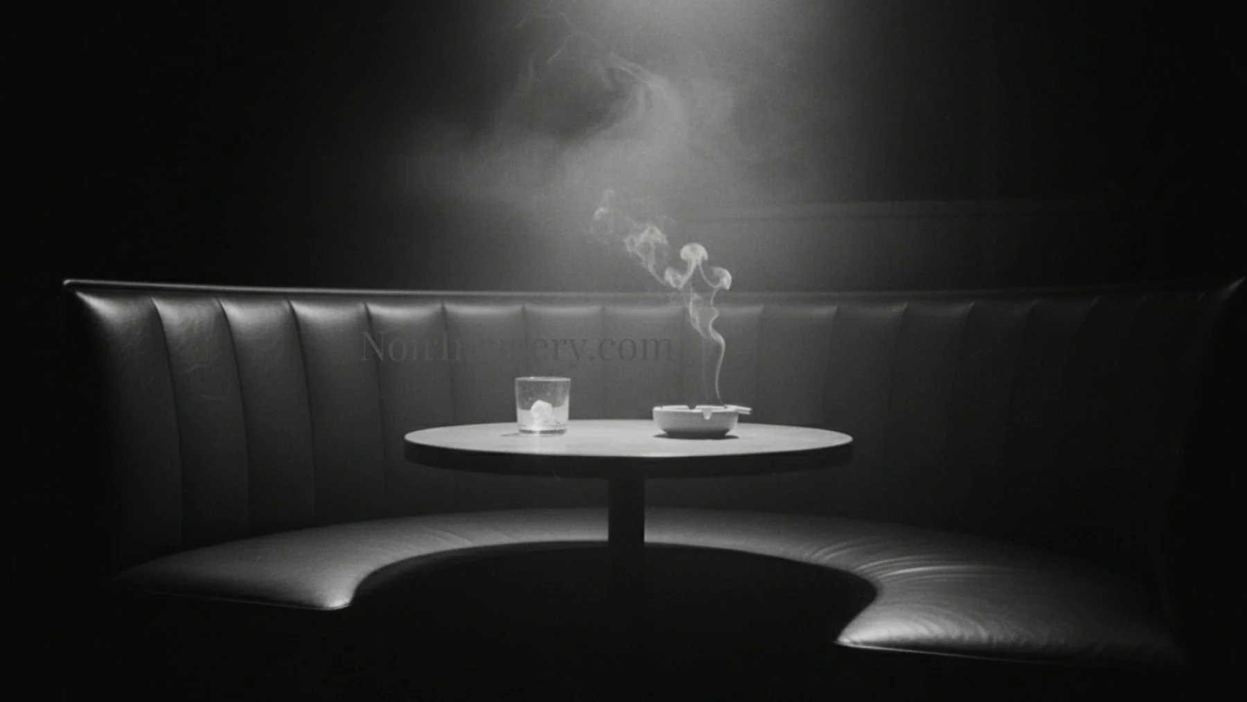 Empty booth with burning cigarette. Someone was here.