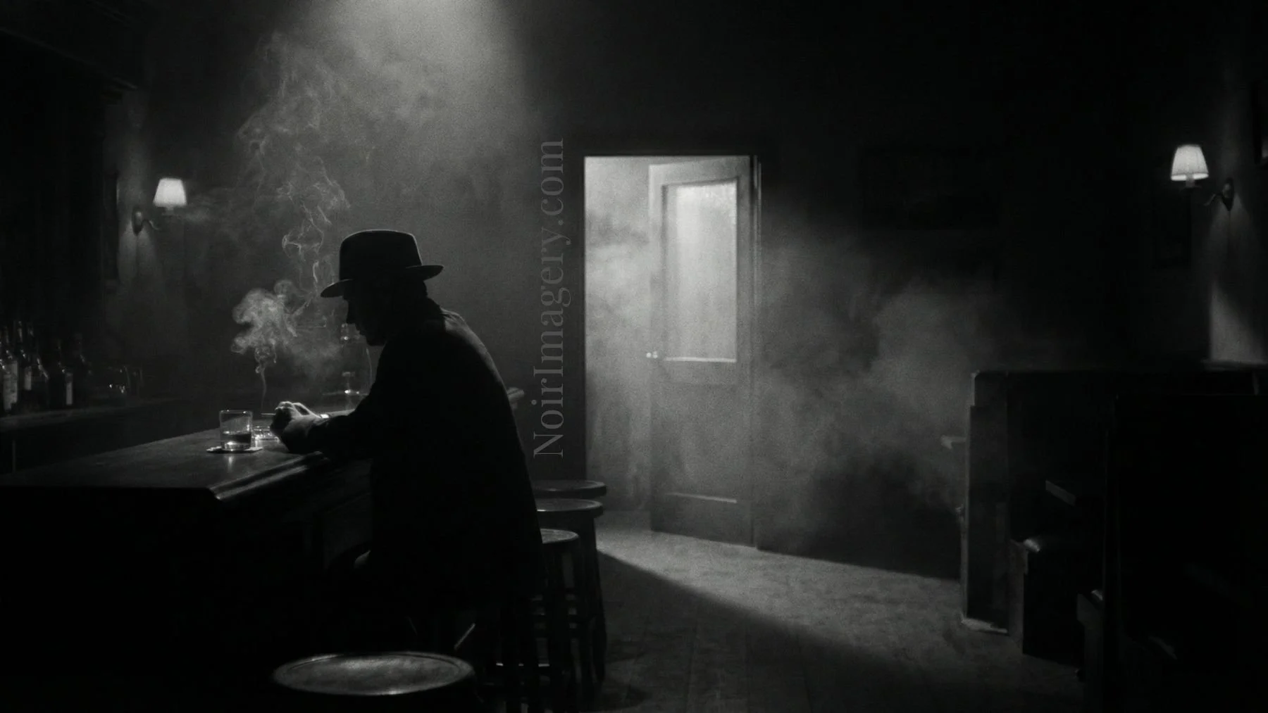 Man sitting at bar with backroom door open.