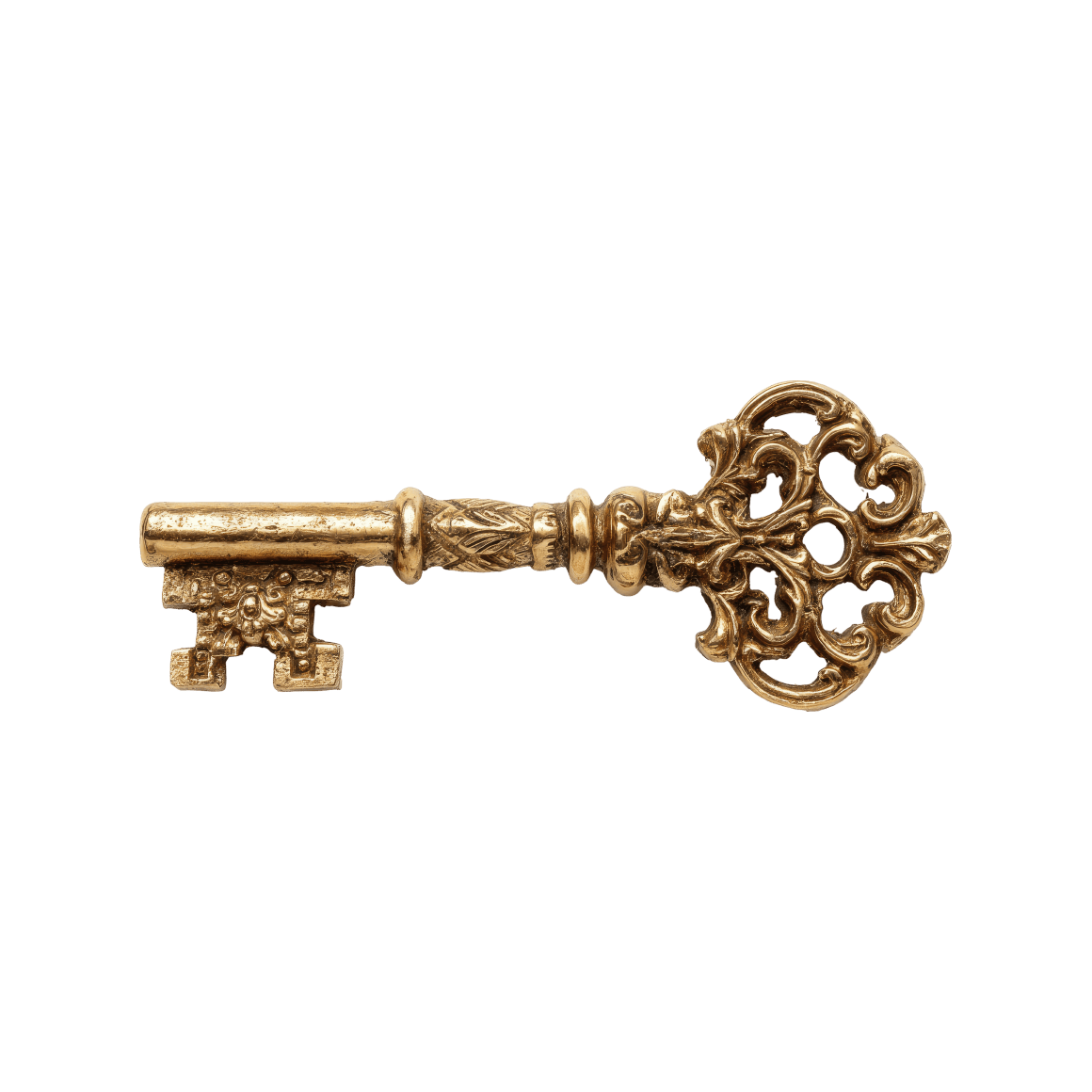 Ornate antique gold key with intricate design and decorative bow.