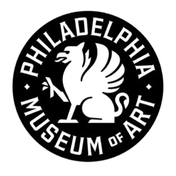 Black circular logo for the Philadelphia Museum of Art featuring a stylized griffin holding an arrow, with the museum's name around the circle.