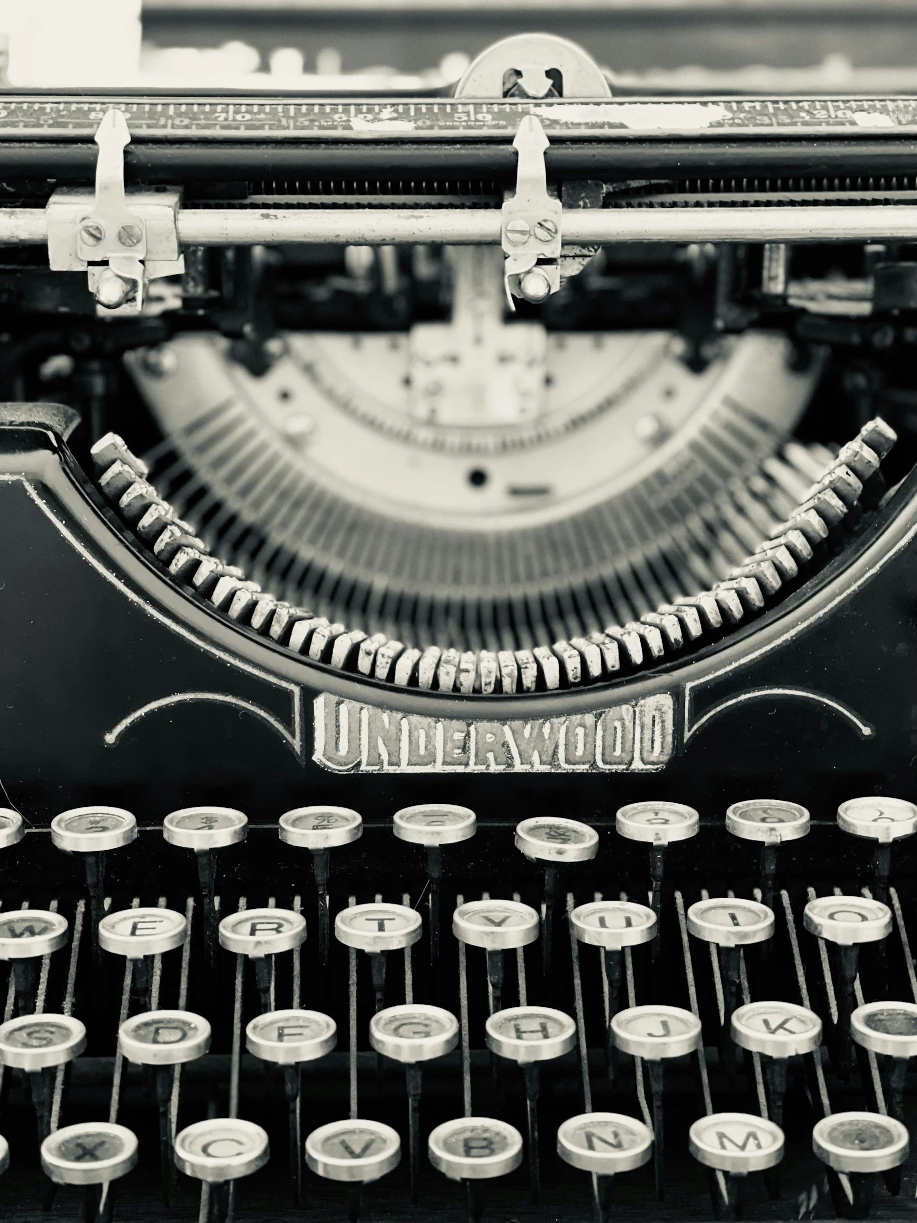 Close-up of a vintage Underwood typewriter with black and white keys and metal components.