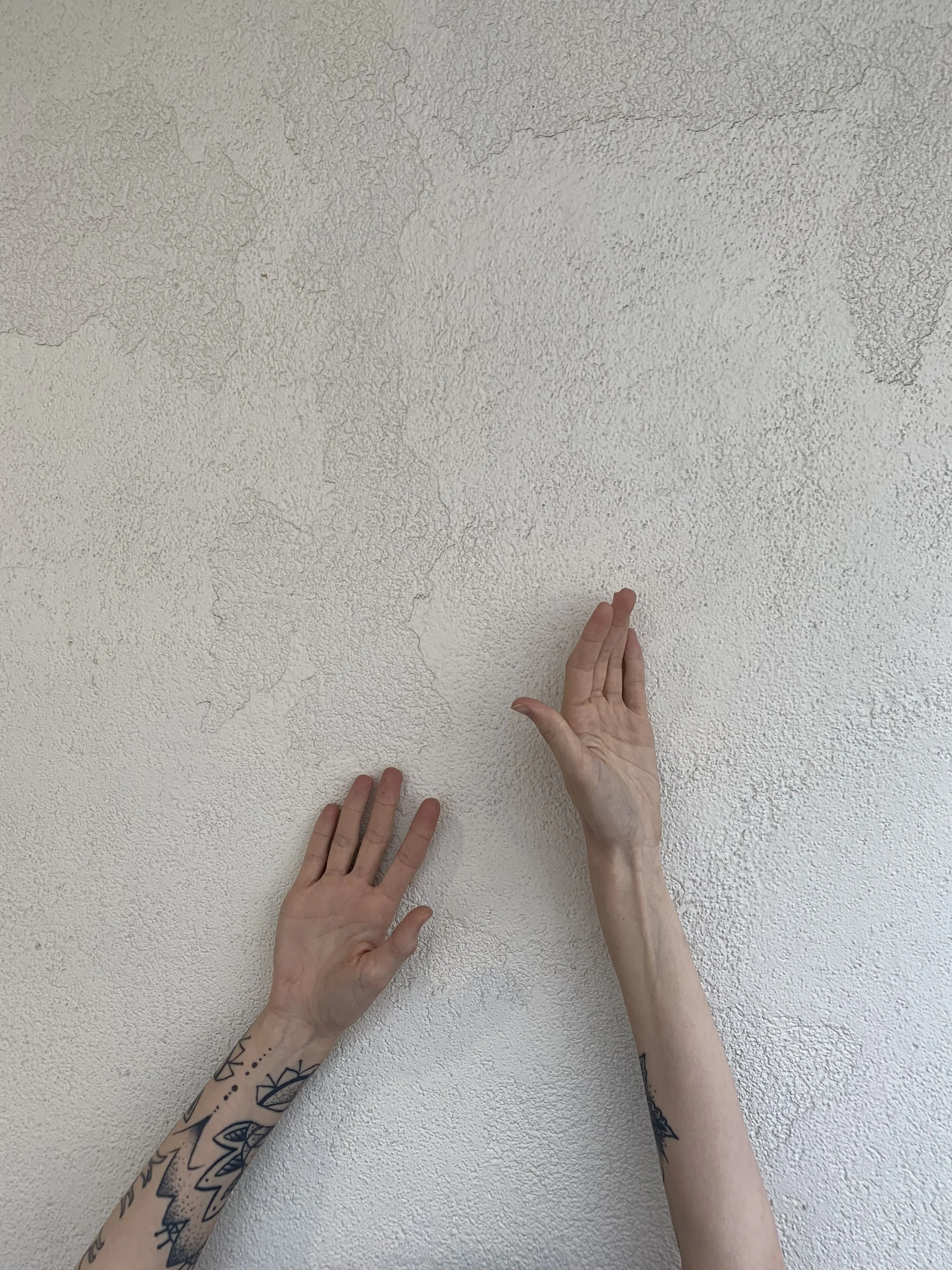 Acupuncture clinic aesthetic image with minimalist arms against neutral wall