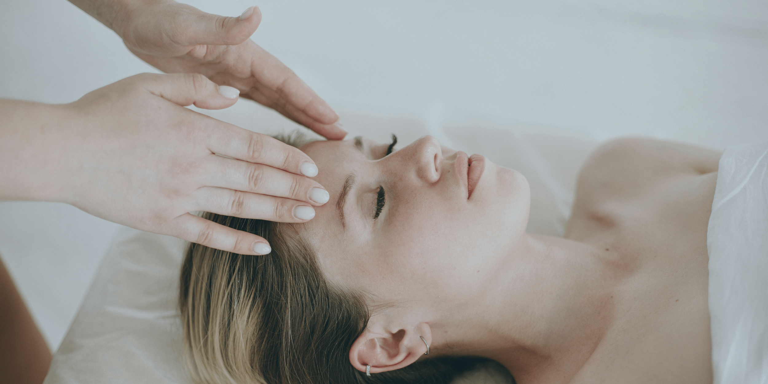 Close-up of a person receiving a massage on their back from a massage therapist.
