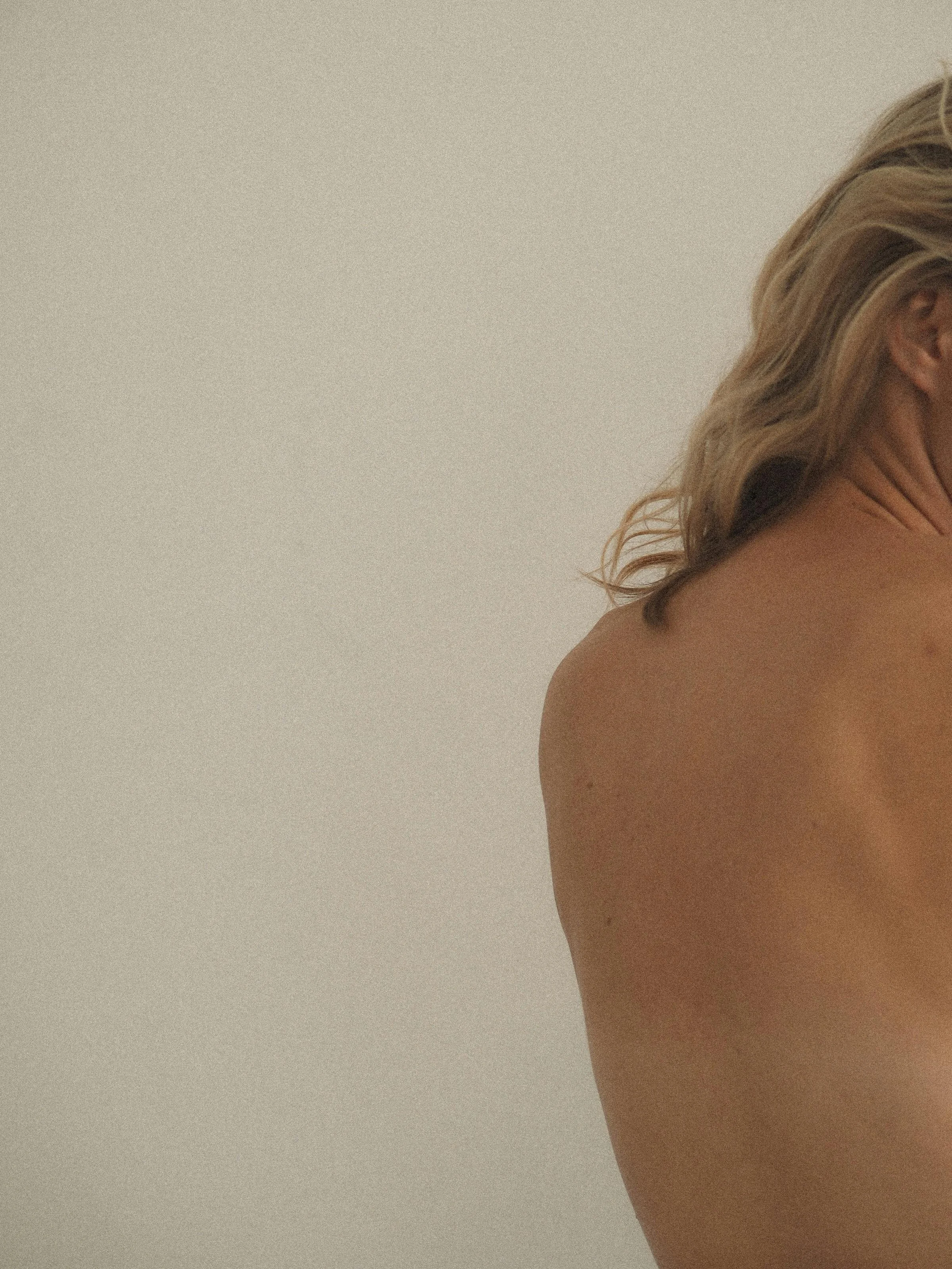 Woman’s back and shoulder, representing Adjust + Align’s chiropractic philosophy and body-aware approach