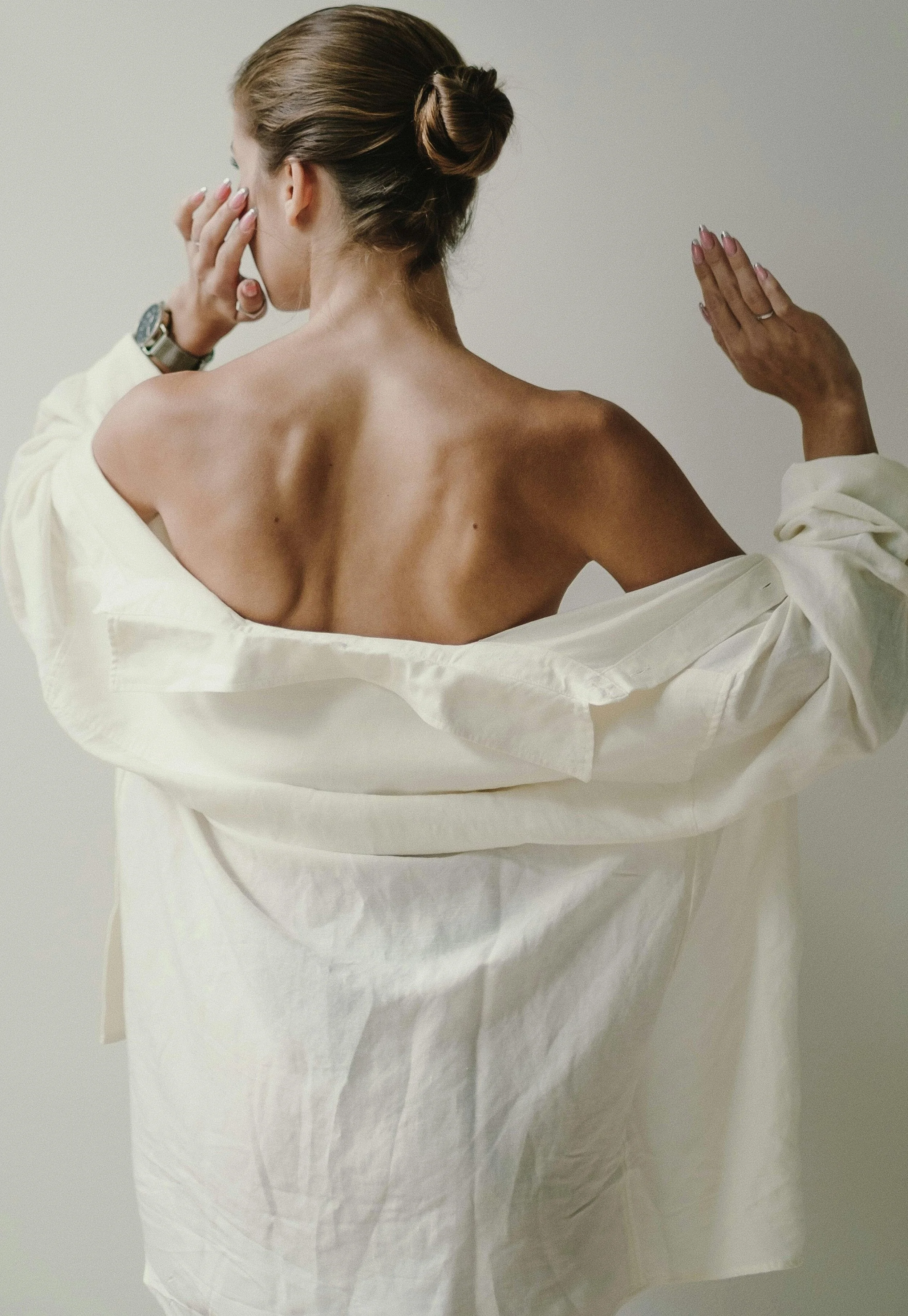 Back of a person in a white shirt, representing support, ease, and chiropractic care at Adjust + Align