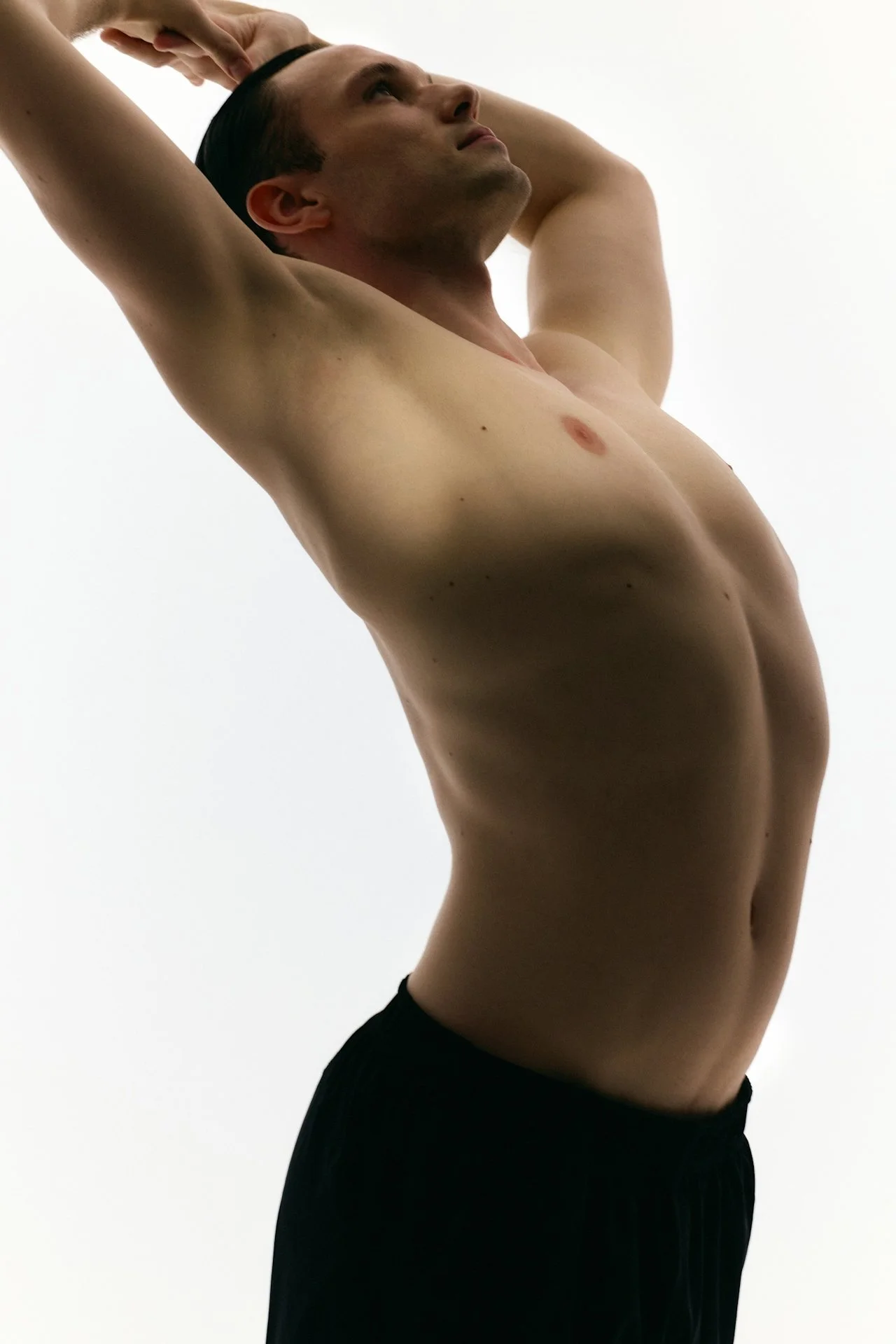 Person stretching with arms overhead, representing movement-based therapy and body support