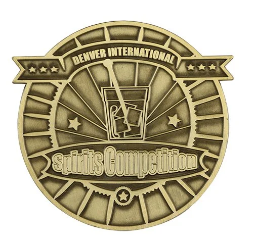 A circular wooden award plaque for the Denver International Spirits Competition, featuring a martini glass with a drink and an olive, surrounded by stars and a banner.