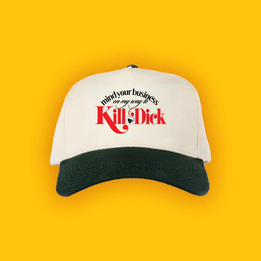 White baseball cap with black brim, featuring the text 'mind your business on my way to Kill Dick' printed on the front, set against a yellow background.