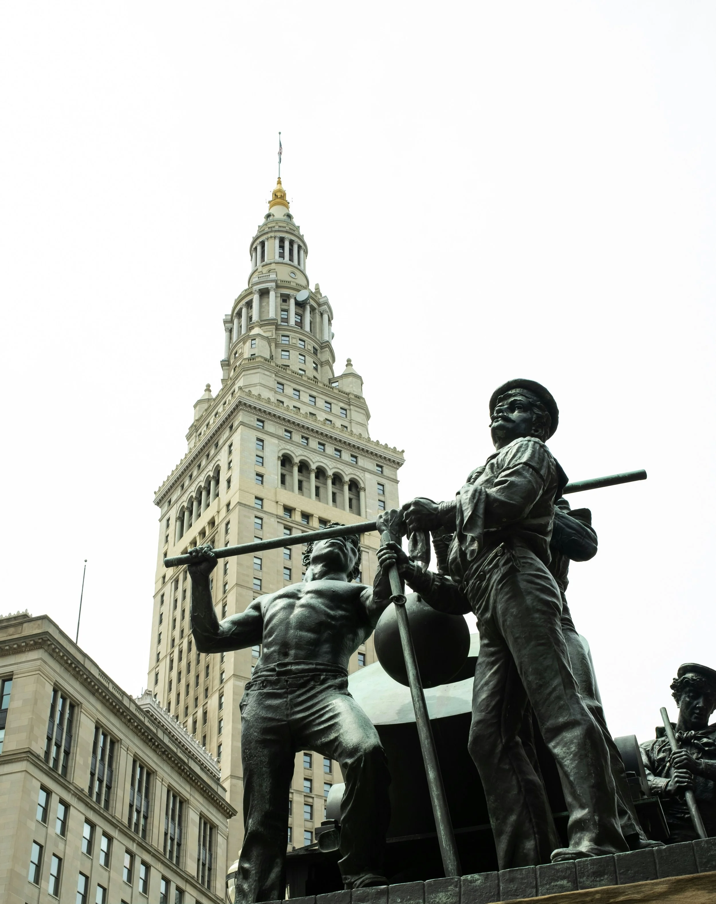 Statue of workers with tools in front of the Manhattan Municipal Building in New York City.