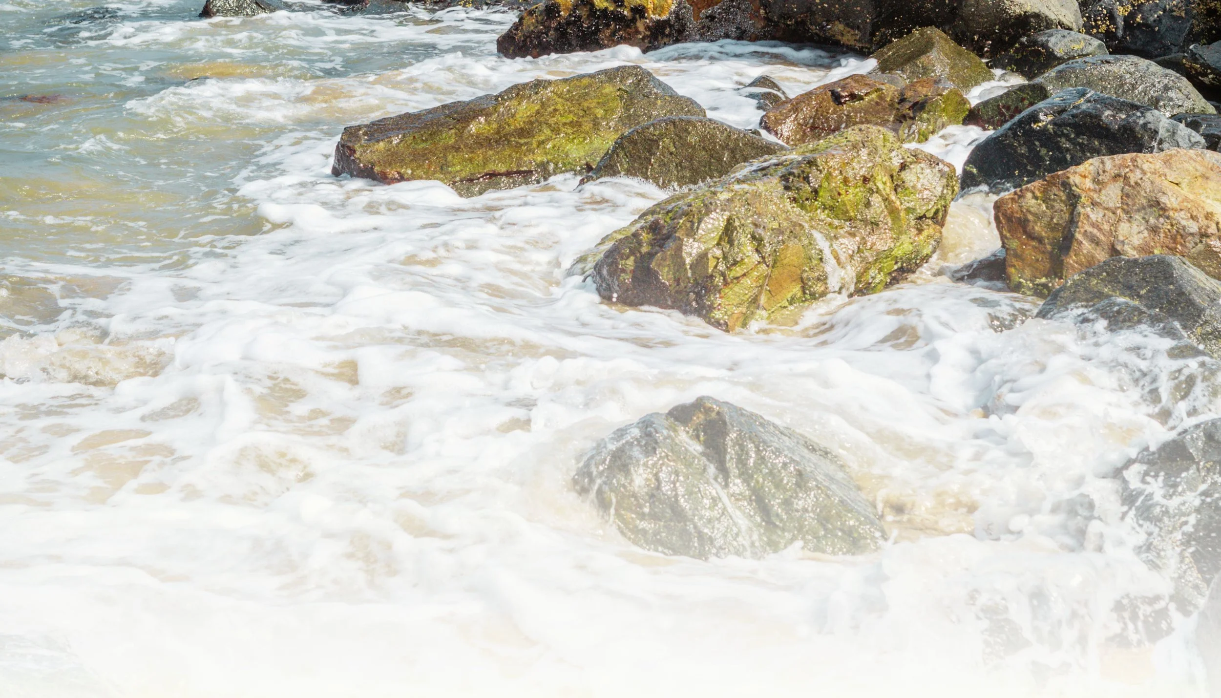 Waves crashing against rocks at the shoreline