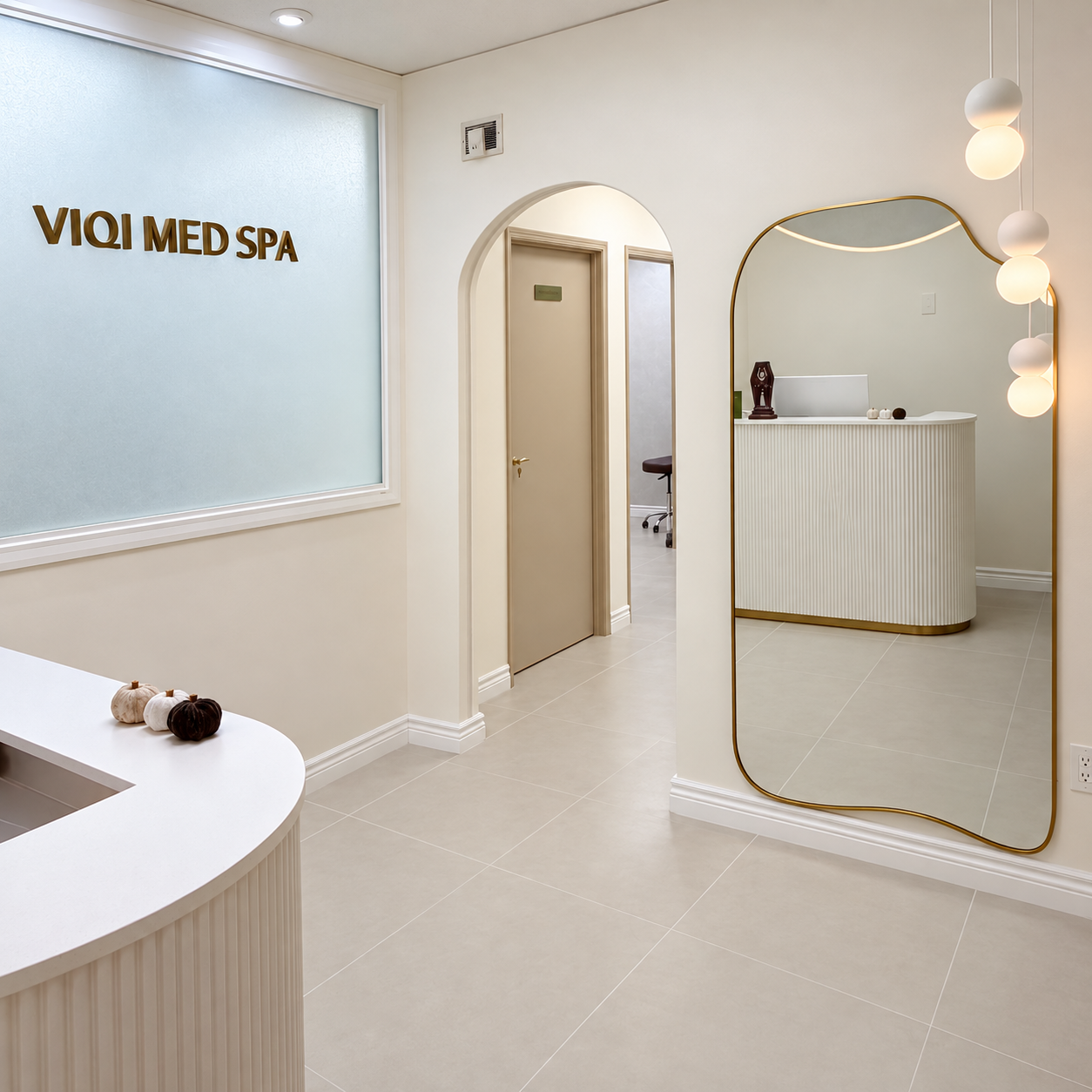 VIQI Med Spa reception area with gold logo, arched doorway and mirror.