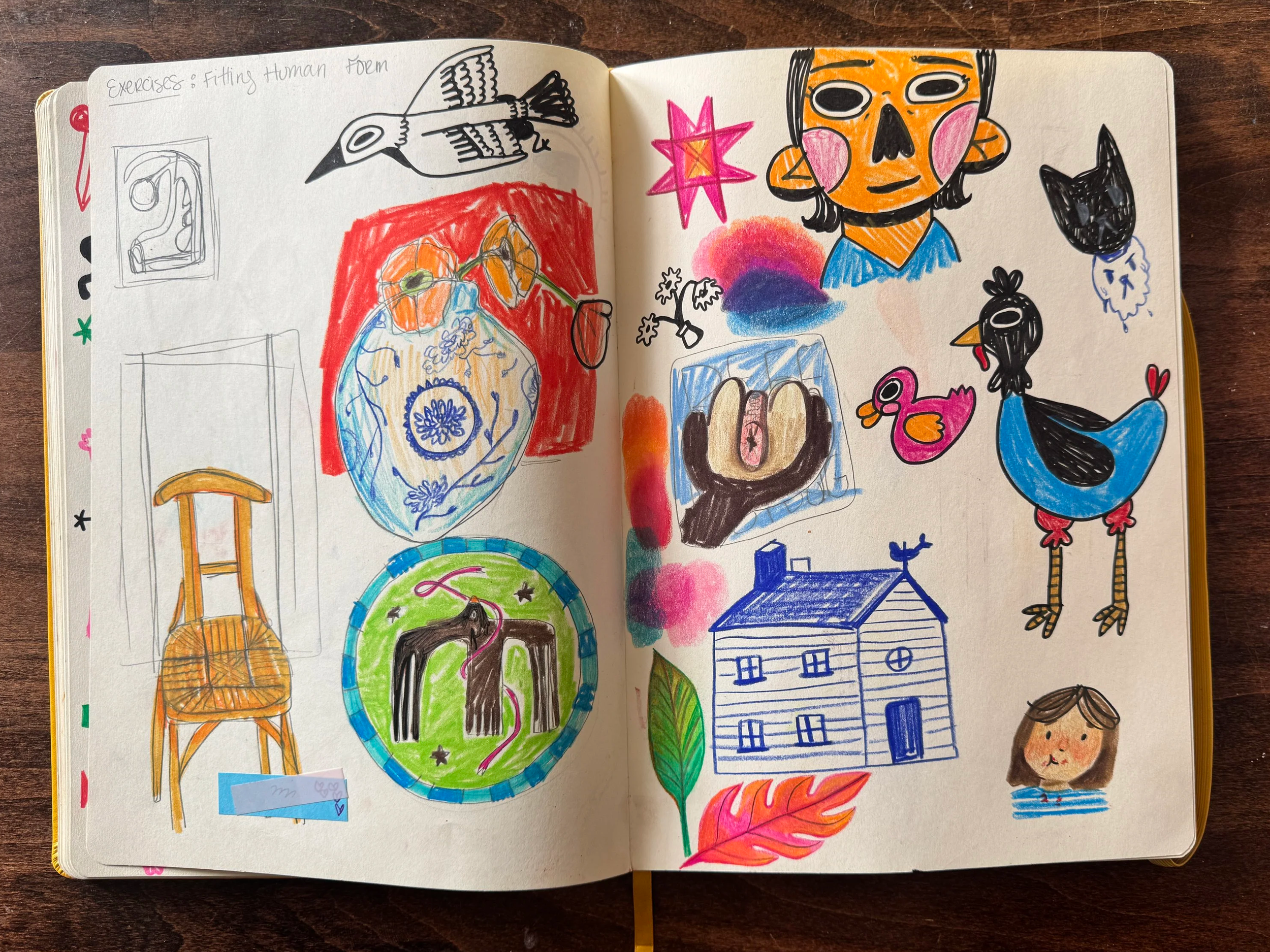 A sketchbook page filled with colorful drawings including animals, a house, a girl, and various abstract designs.