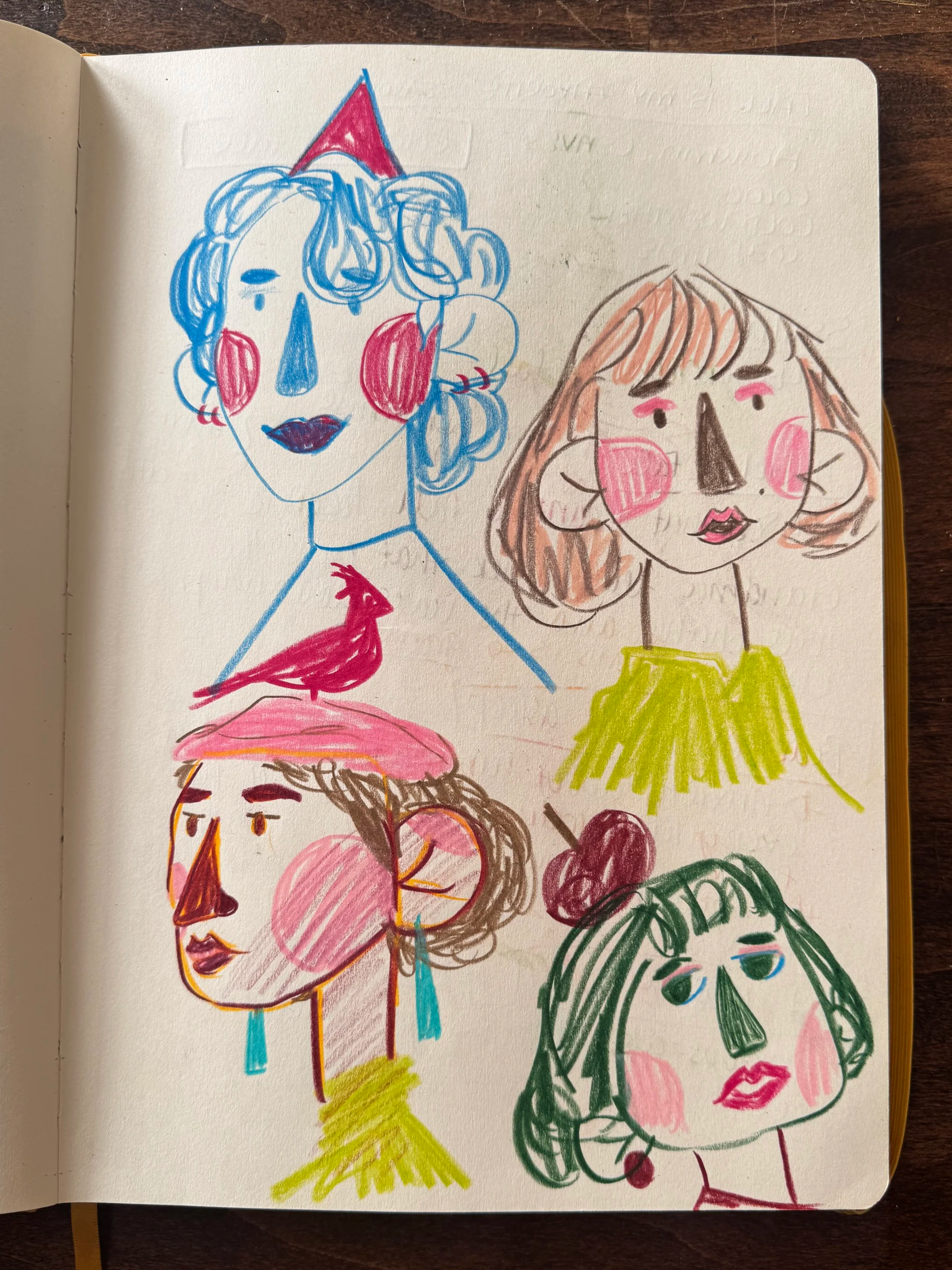 Sketches of five women with exaggerated facial features and colorful accessories, drawn with markers in a sketchbook.