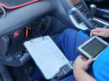 ITV technician checks on board diagnostics on Peugeot 3008 during import test. New Spanish testing regulations introduced in September 2018 demand that all Euro 5 and Euro 6 passenger vehicles are to be plugged in to on board diagnostic equipment to 