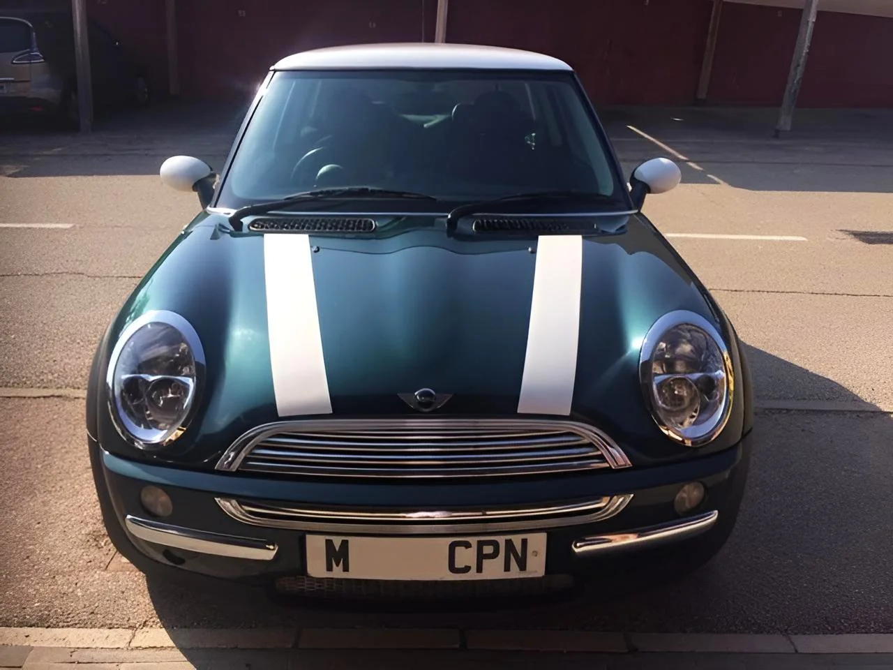 Green Mini front view with two white racing stripes